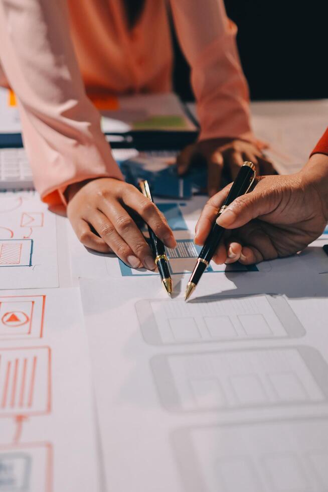Young Asian business creative team work together, mobile application software design project. Brainstorm meeting, internet technology, smartphone web app designer, office coworker teamwork concept photo