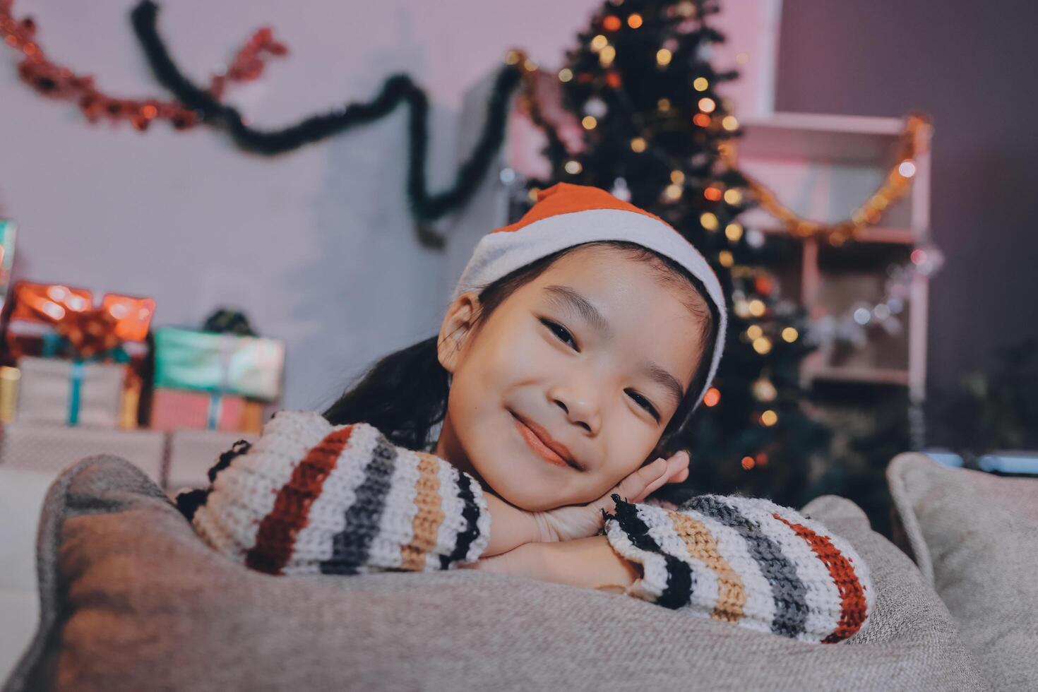 christmas, x-mas, winter, happiness concept - dreaming girl in santa helper hat photo