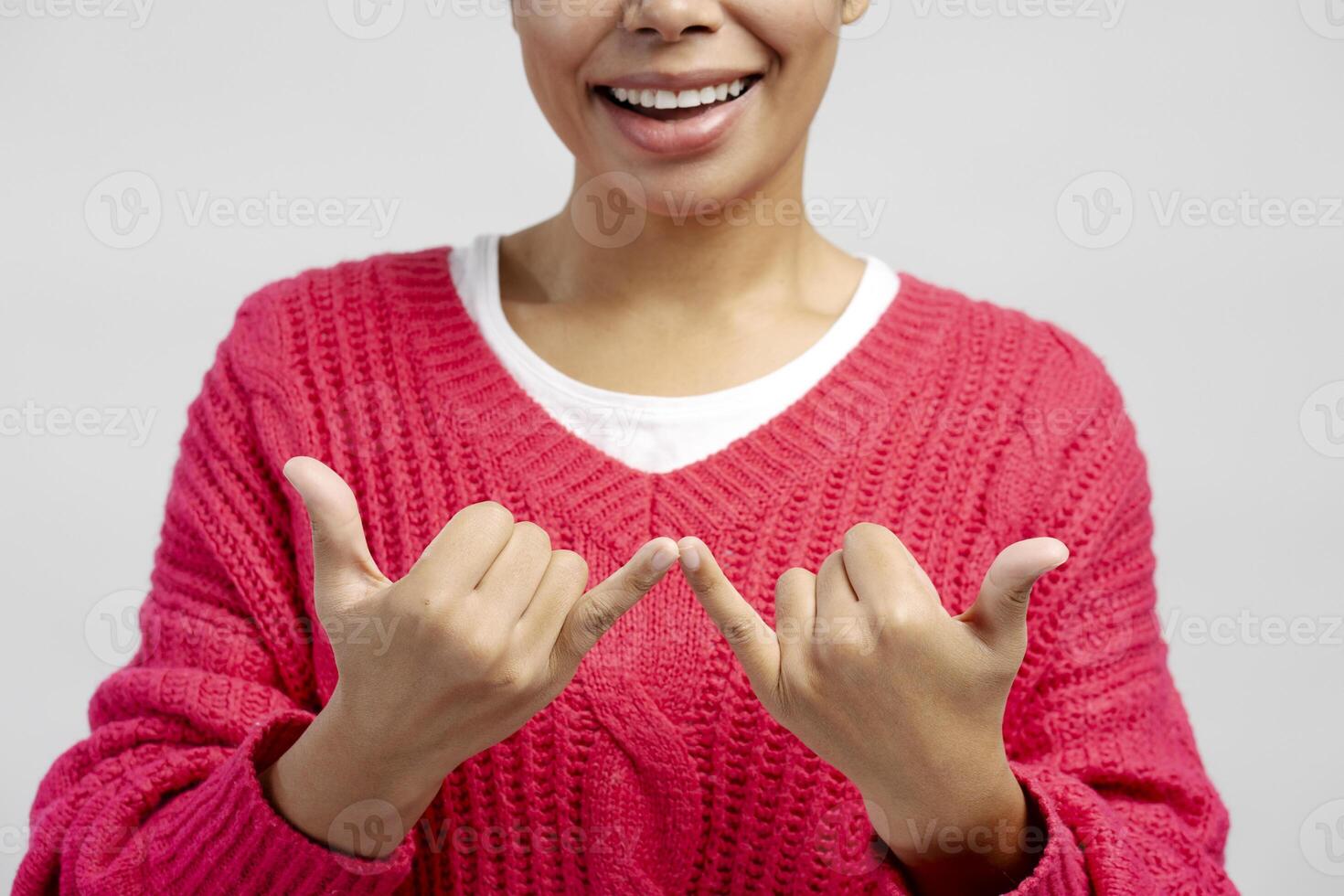 Young woman showing korean finger heart, expressing love and affection photo