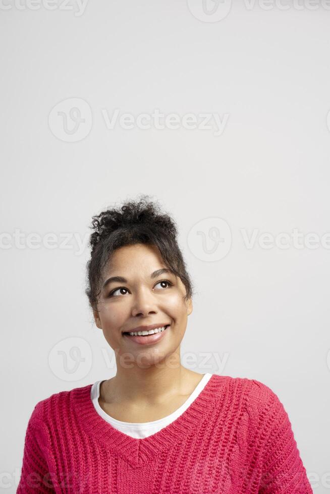 Young woman looking up and smiling, expressing hope and positivity photo