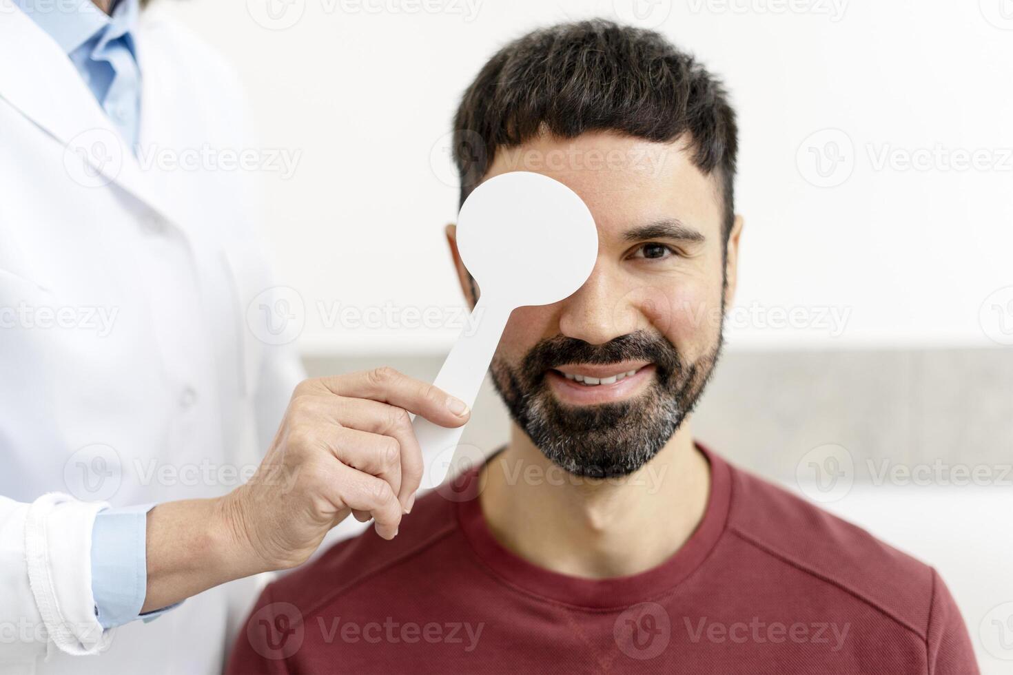 Doctor checking patient eyesight with occluder in medical clinic photo