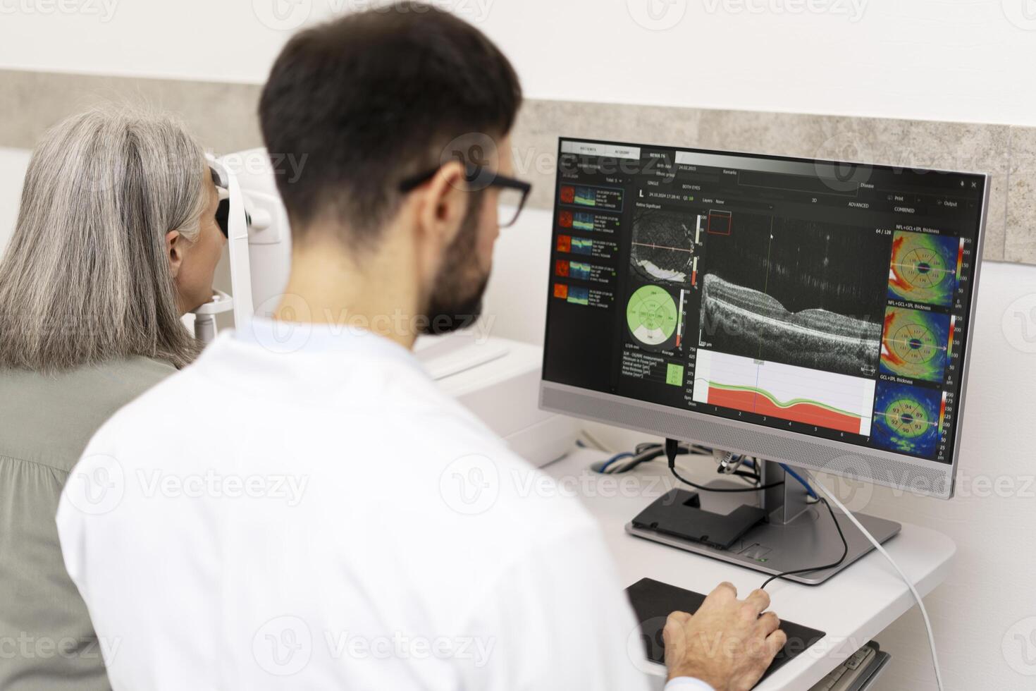Ophthalmologist analyzing optical coherence tomography scan results on computer photo