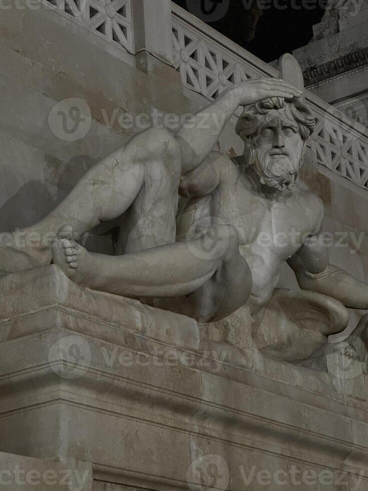 Detailed sculpture of a reclining figure with a beard and intricate draper photo