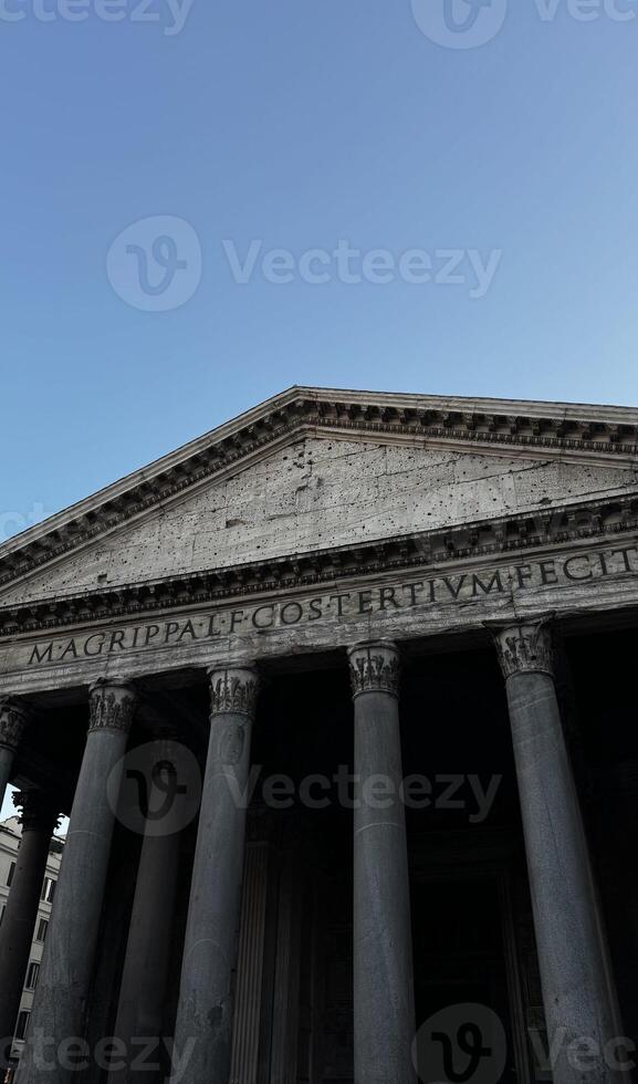 Majestic architecture of ancient Roman Pantheon showcases stunning columns under a clear blue sky in the heart of Rome highlighting its historical significance and timeless beauty photo