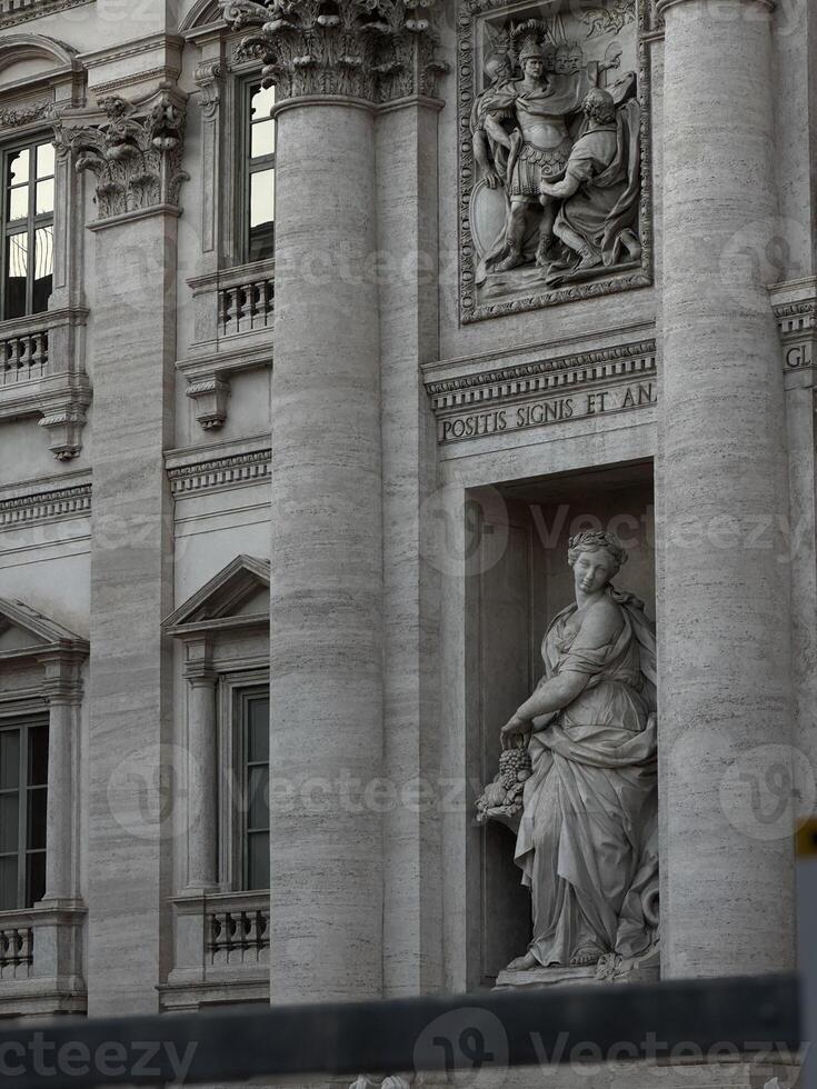 Majestic sculpture and intricate architecture at a historical building in Rome, Italy, showcasing timeless artistry in bright daylight photo