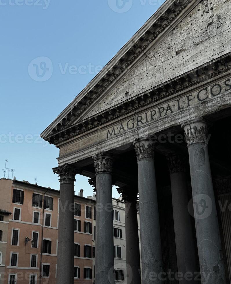 Majestic architecture of the Pantheon in Rome showcasing ancient columns against a blue sky at sunset photo
