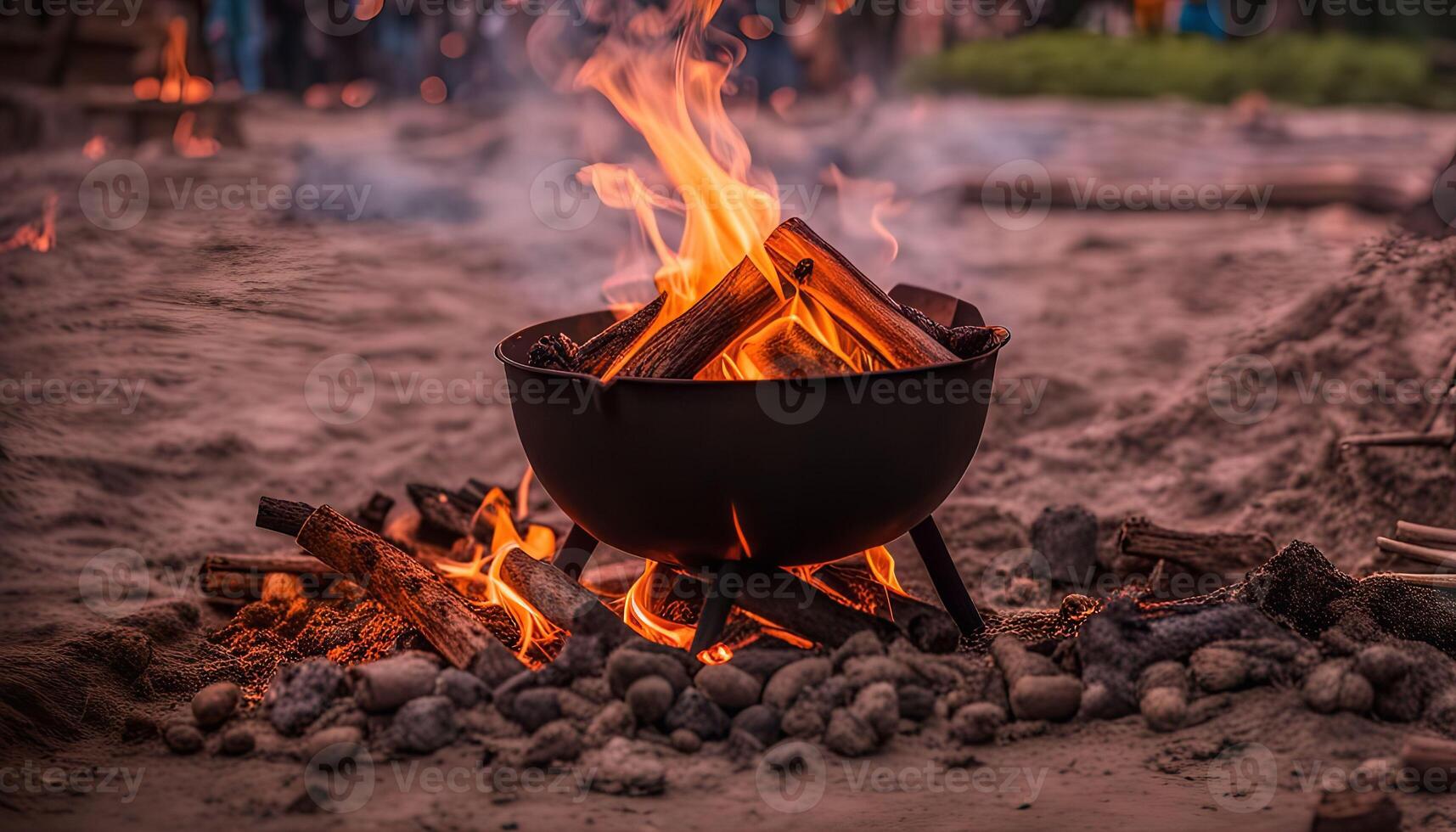 Campfire in a Metal Bowl on Sandy Ground photo