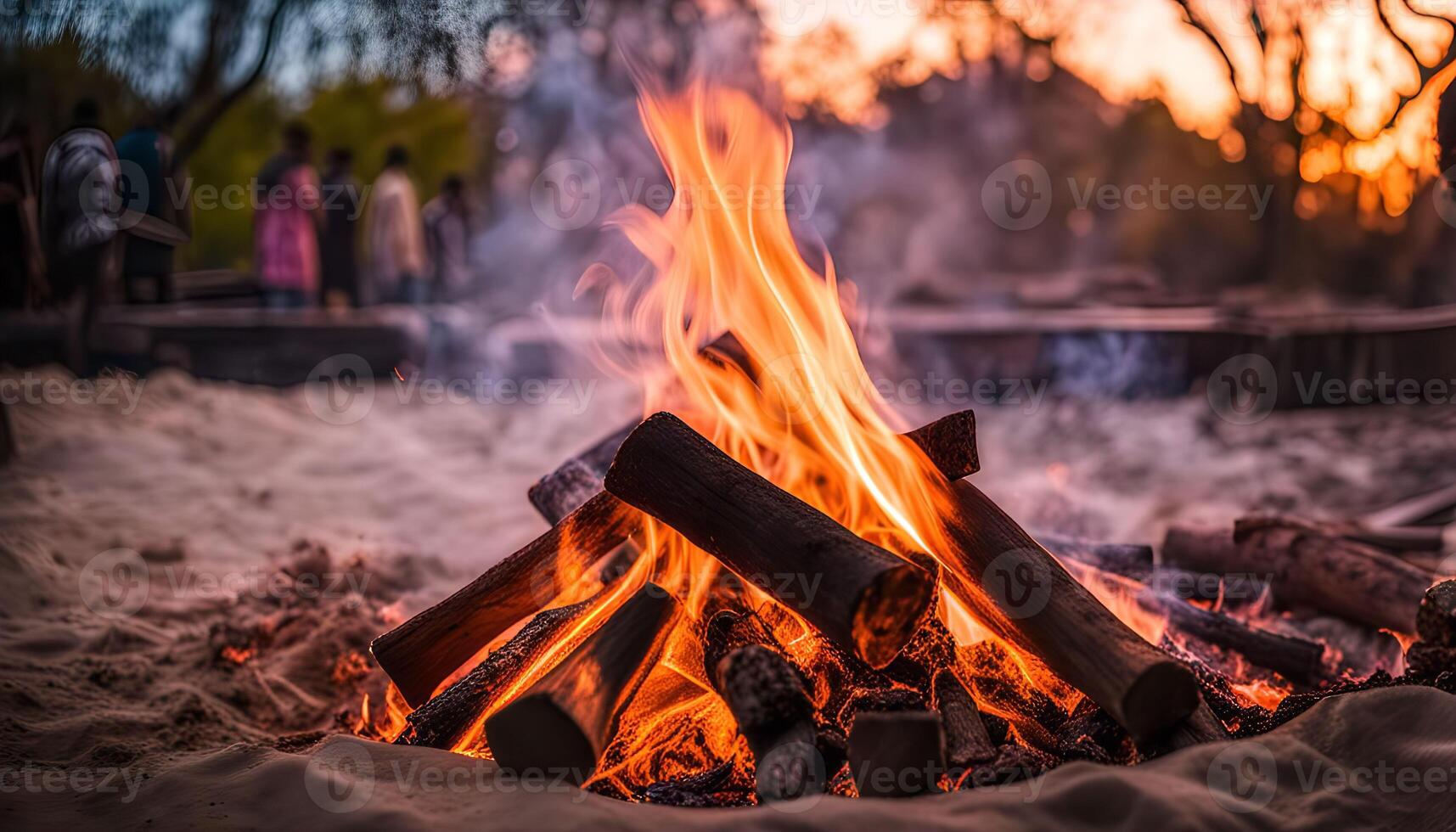 Campfire at Sunset with Blurry People in Background photo