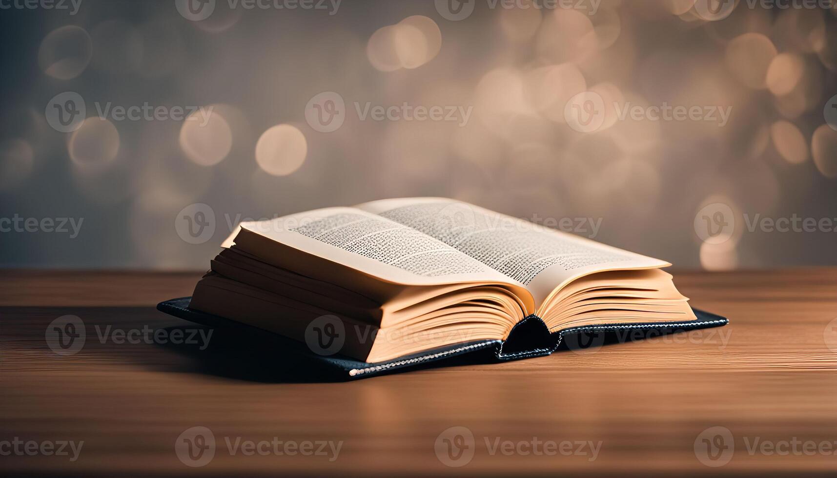 Open Book on Wooden Table with Bokeh Background photo