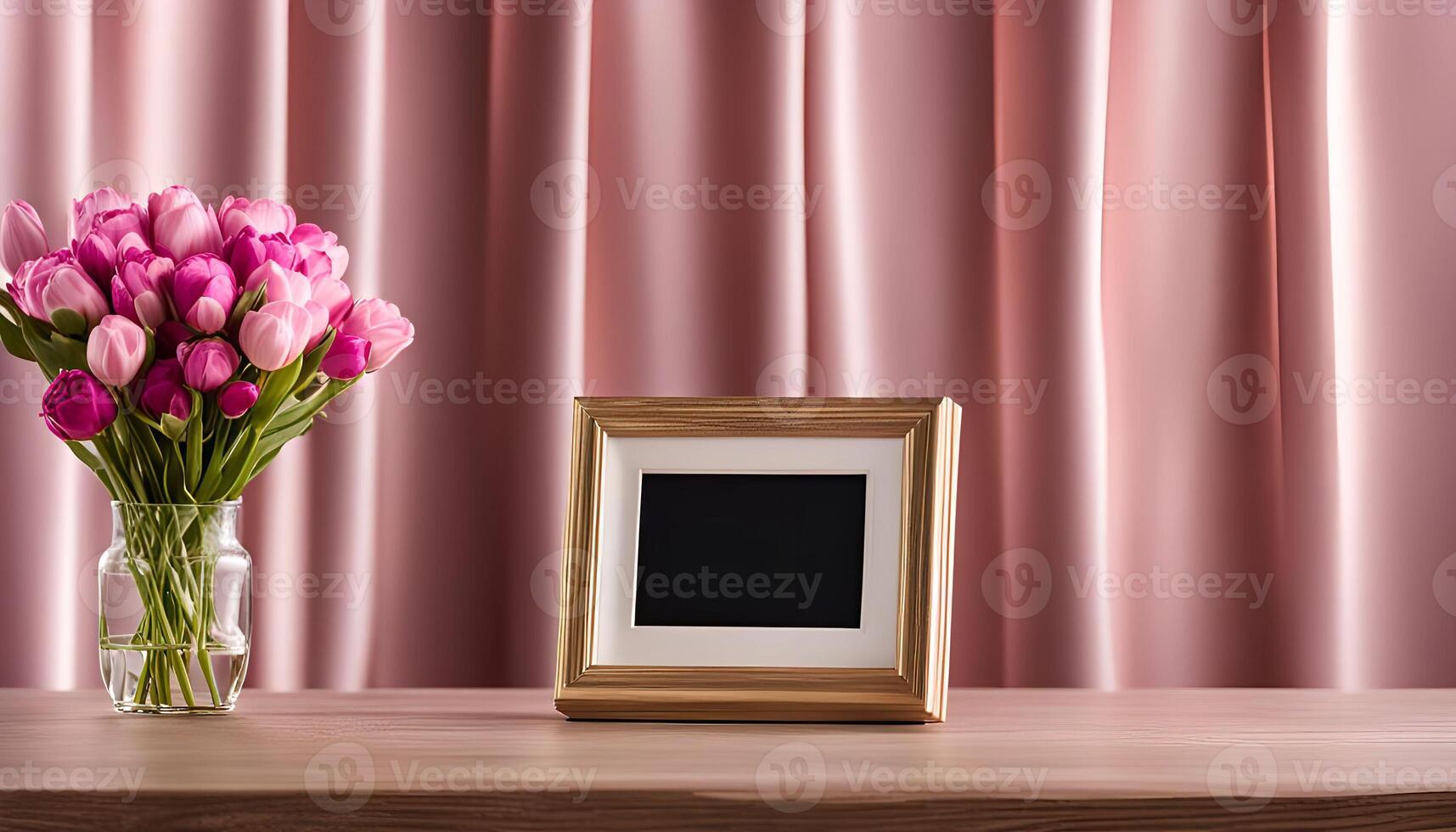Pink Tulips in a Vase and a Picture Frame on a Wooden Table photo