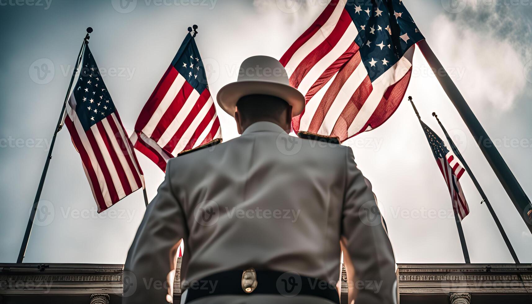 A soldier in uniform standing in front of the American flag photo