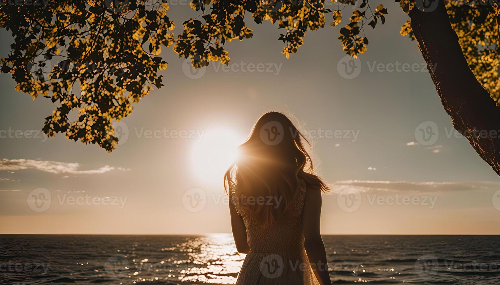 Silhouette of a Woman Watching the Sunset Over the Ocean photo