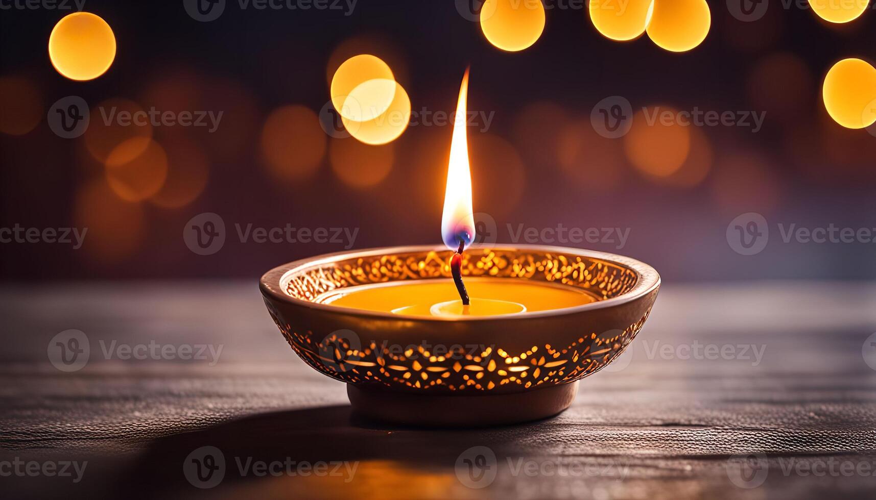 Burning Candle in a Golden Diya photo