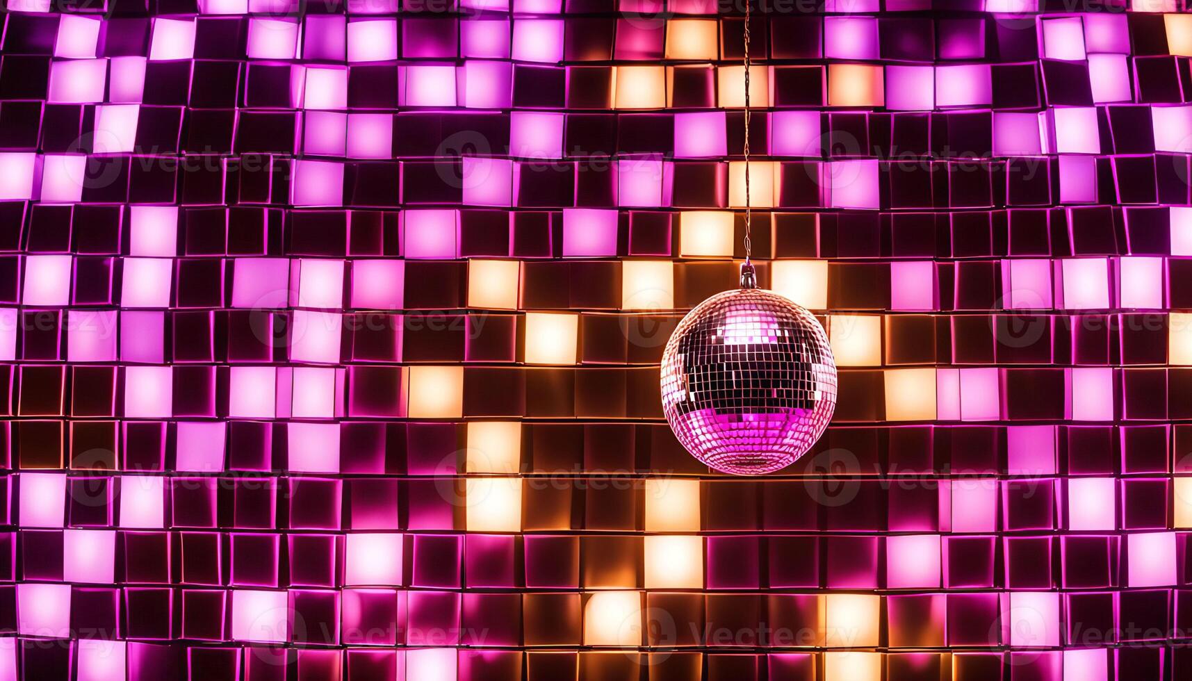 Disco Ball Hanging From a Ceiling Against a Background of Pink and Yellow Lights photo