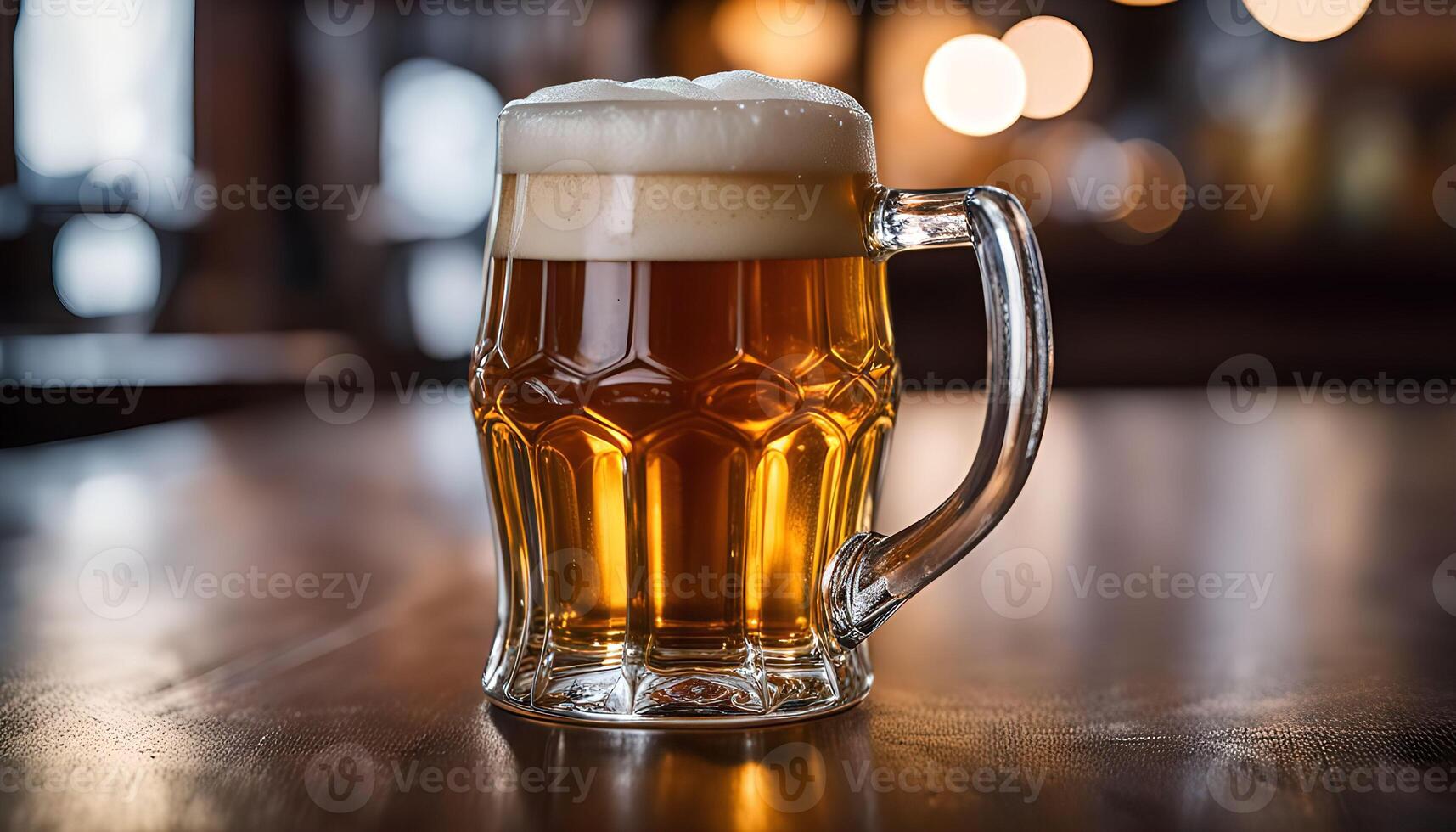 A frosty glass of beer on a wooden table photo