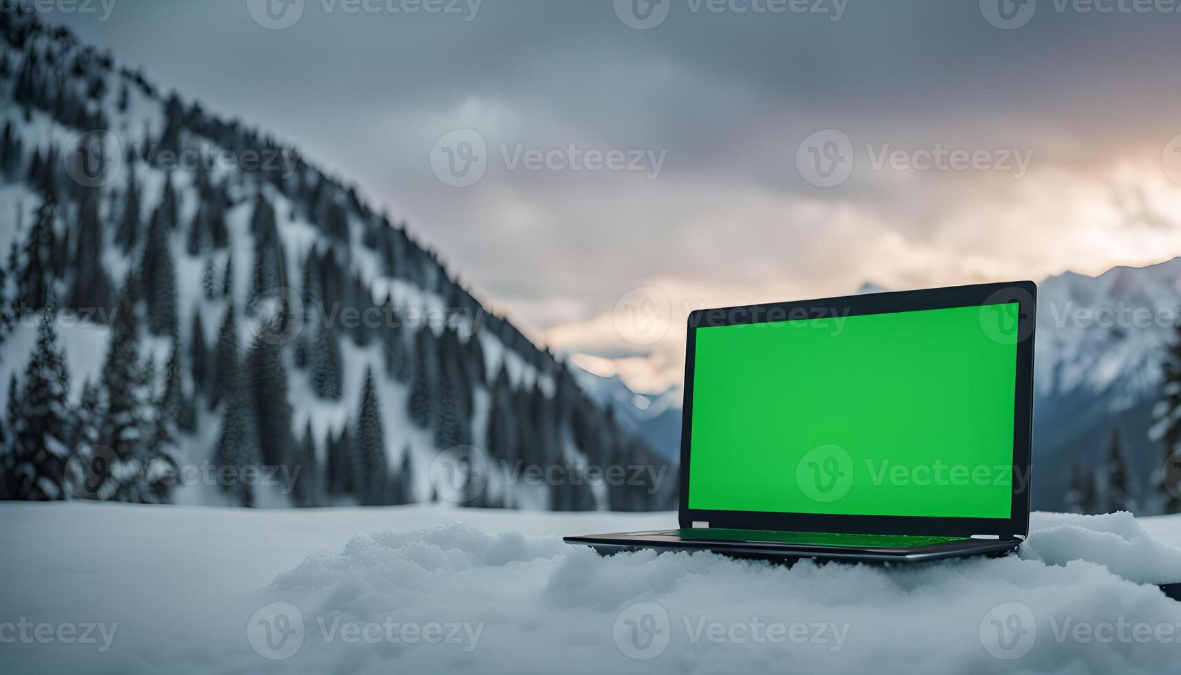 Laptop in the Snowy Mountain Landscape photo