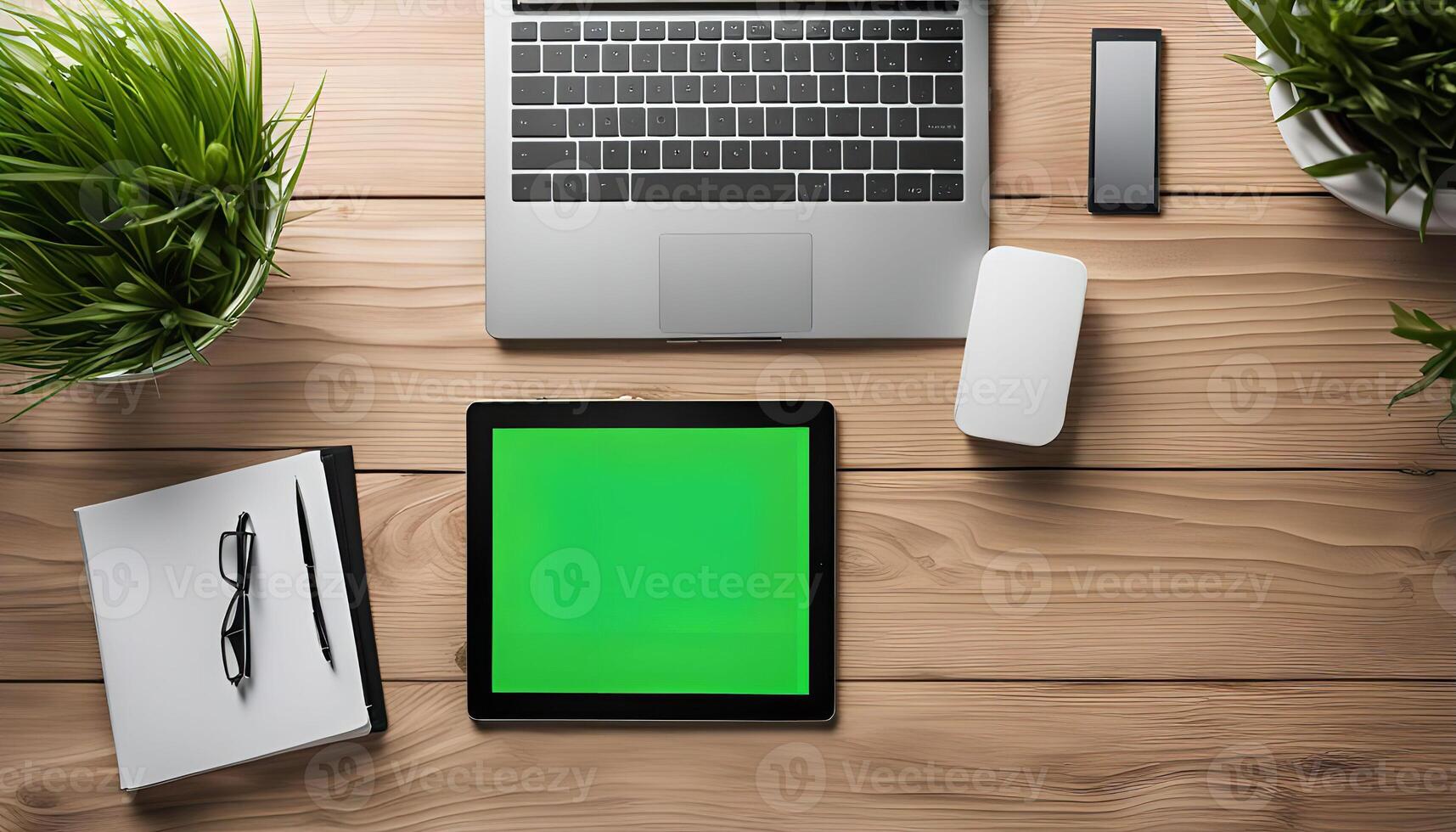 Top View of a Desk with Electronics and Plants photo