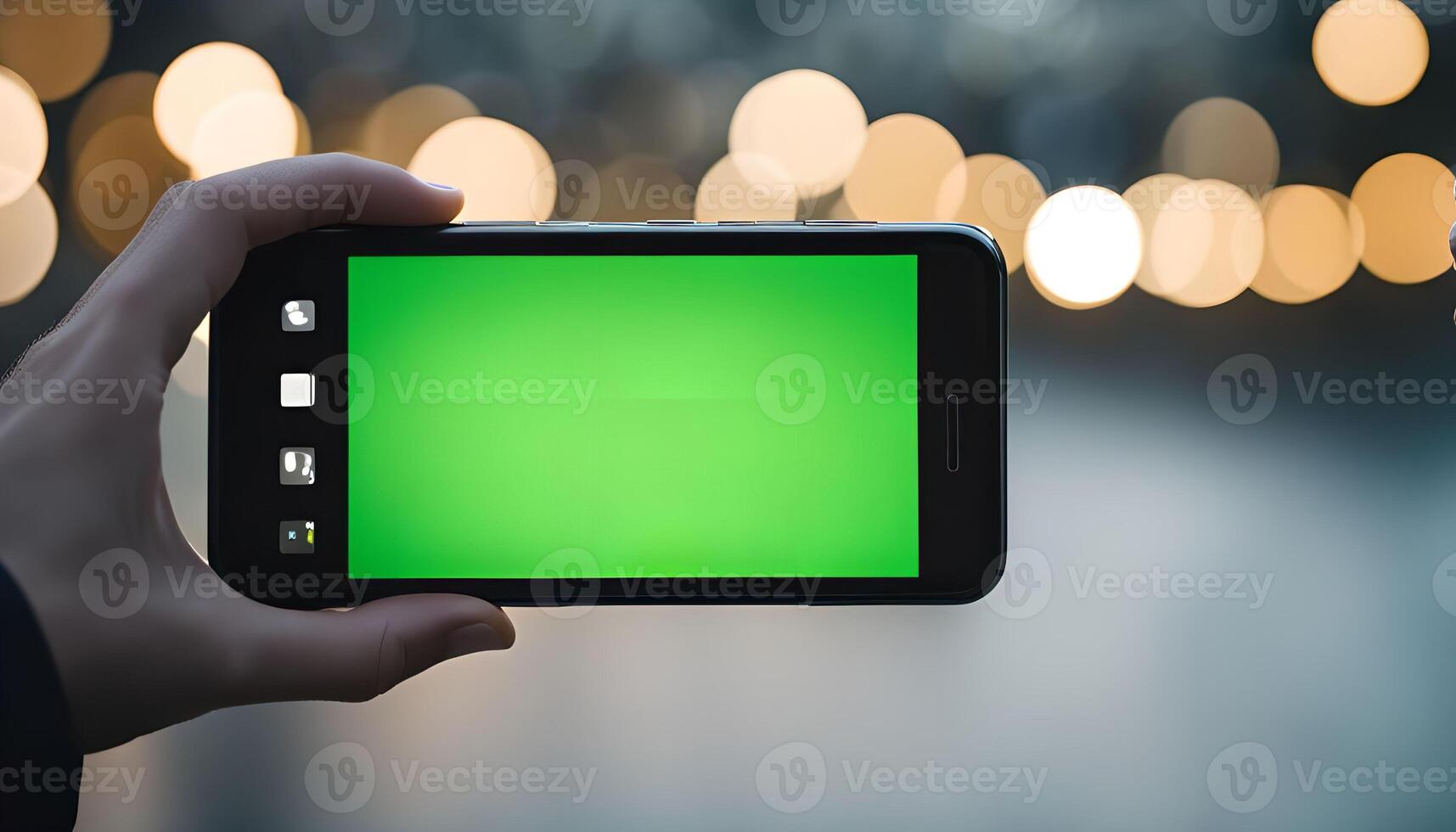 Hand Holding Phone with Green Screen in Blurred Background photo