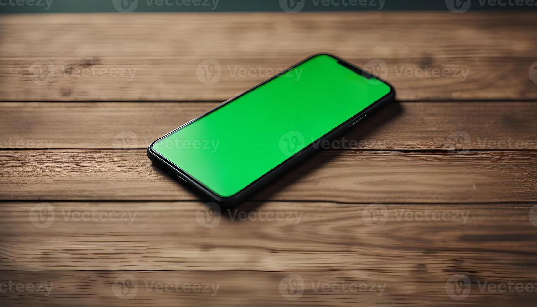 Smartphone on Wooden Table with Green Screen Display photo