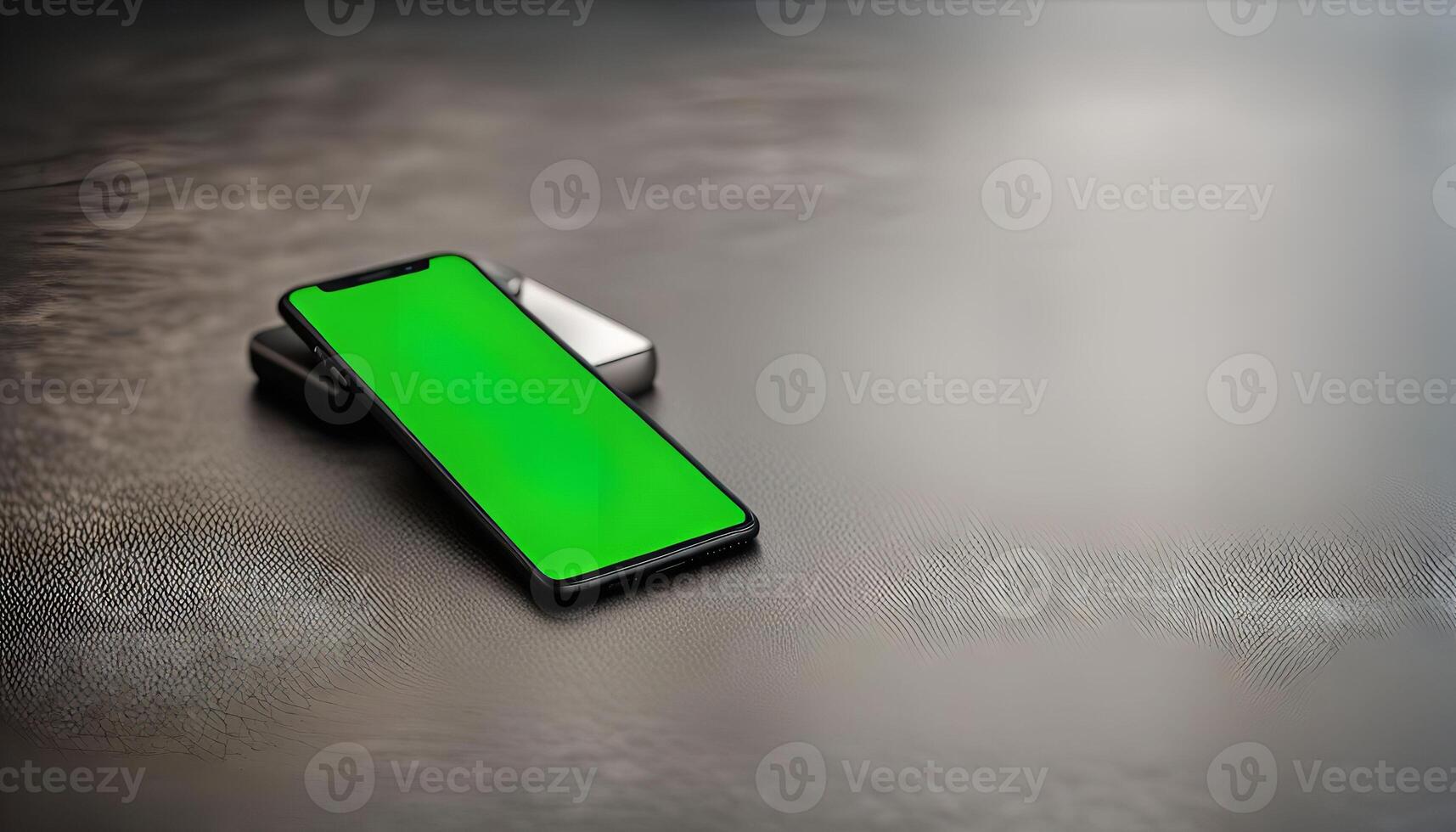 Smartphone with Green Screen on a Grey Surface photo