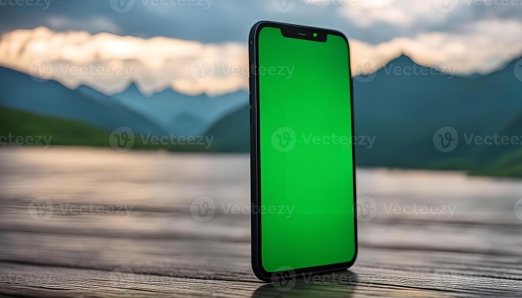 Smartphone with Green Screen in Front of Mountain Landscape photo