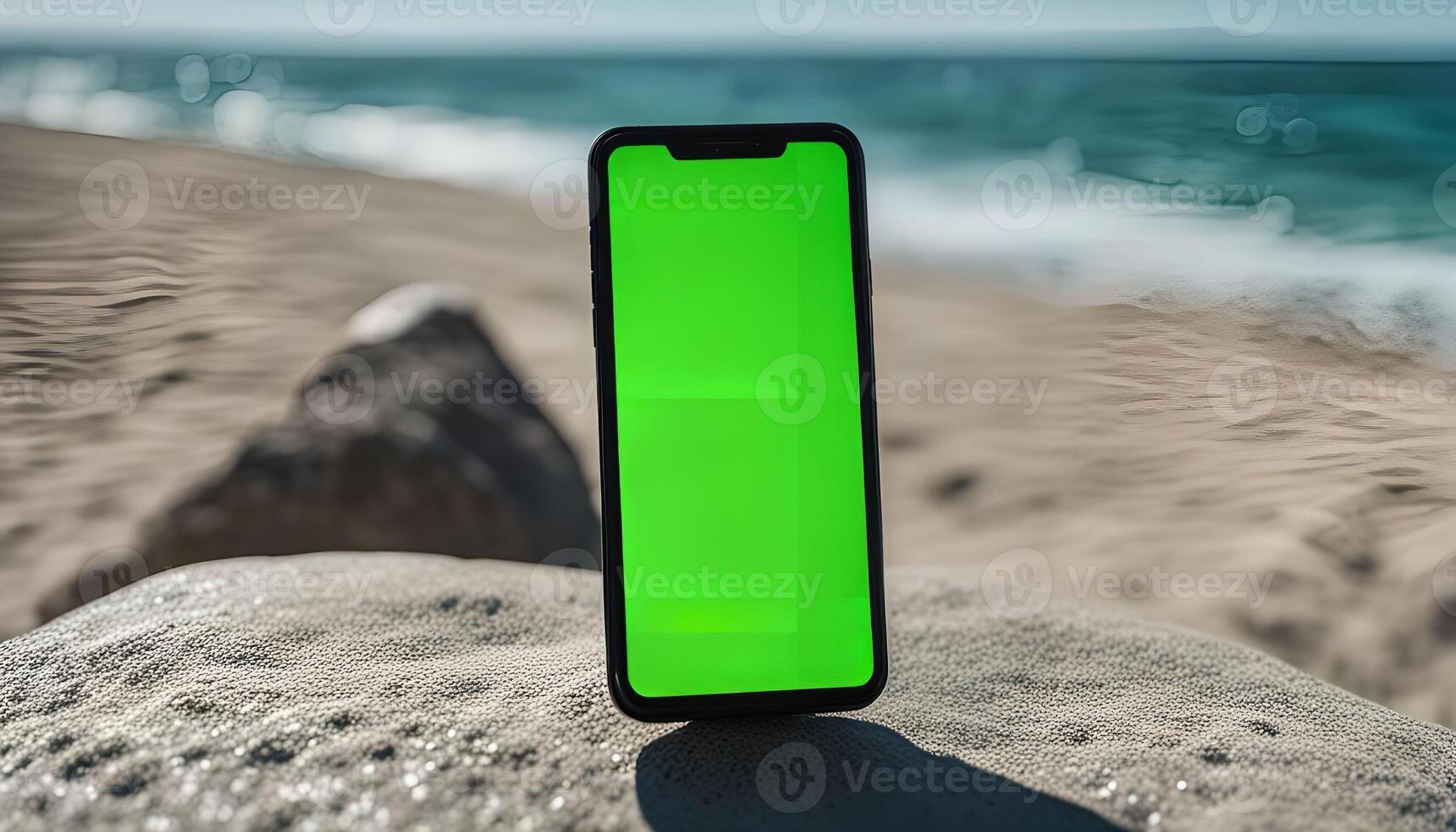 Smartphone on a beach with green screen photo