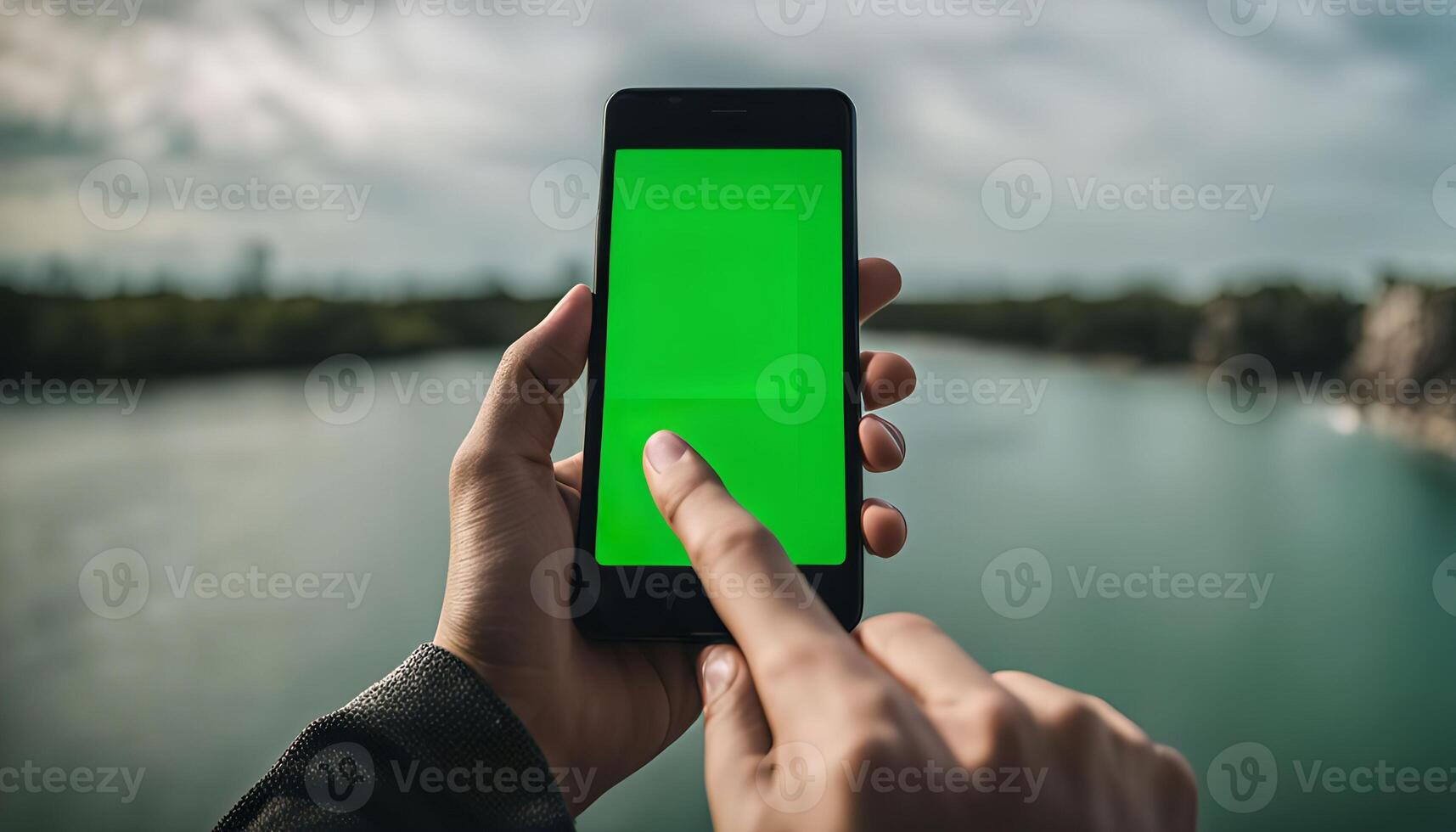 Person holding a Smartphone with a Green Screen Display Outdoors photo