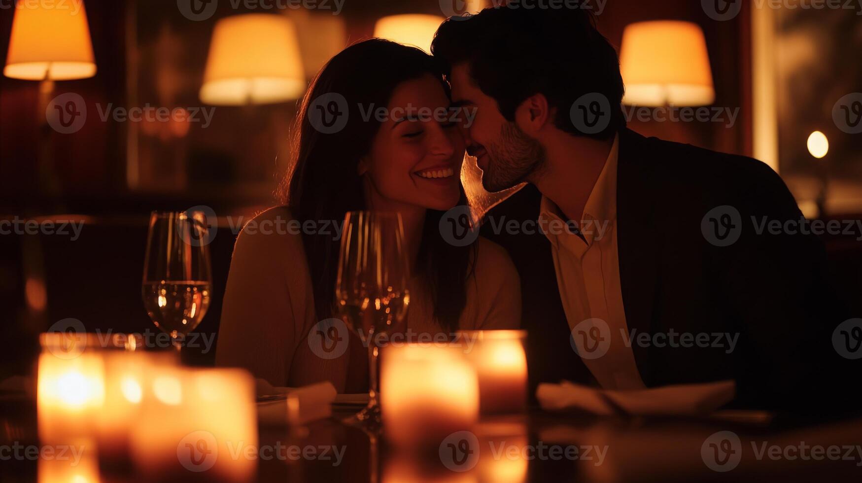A couple enjoys a romantic dinner in a cozy restaurant, surrounded by soft candlelight. They share smiles and closeness, creating a warm, intimate atmosphere that fosters connection. photo