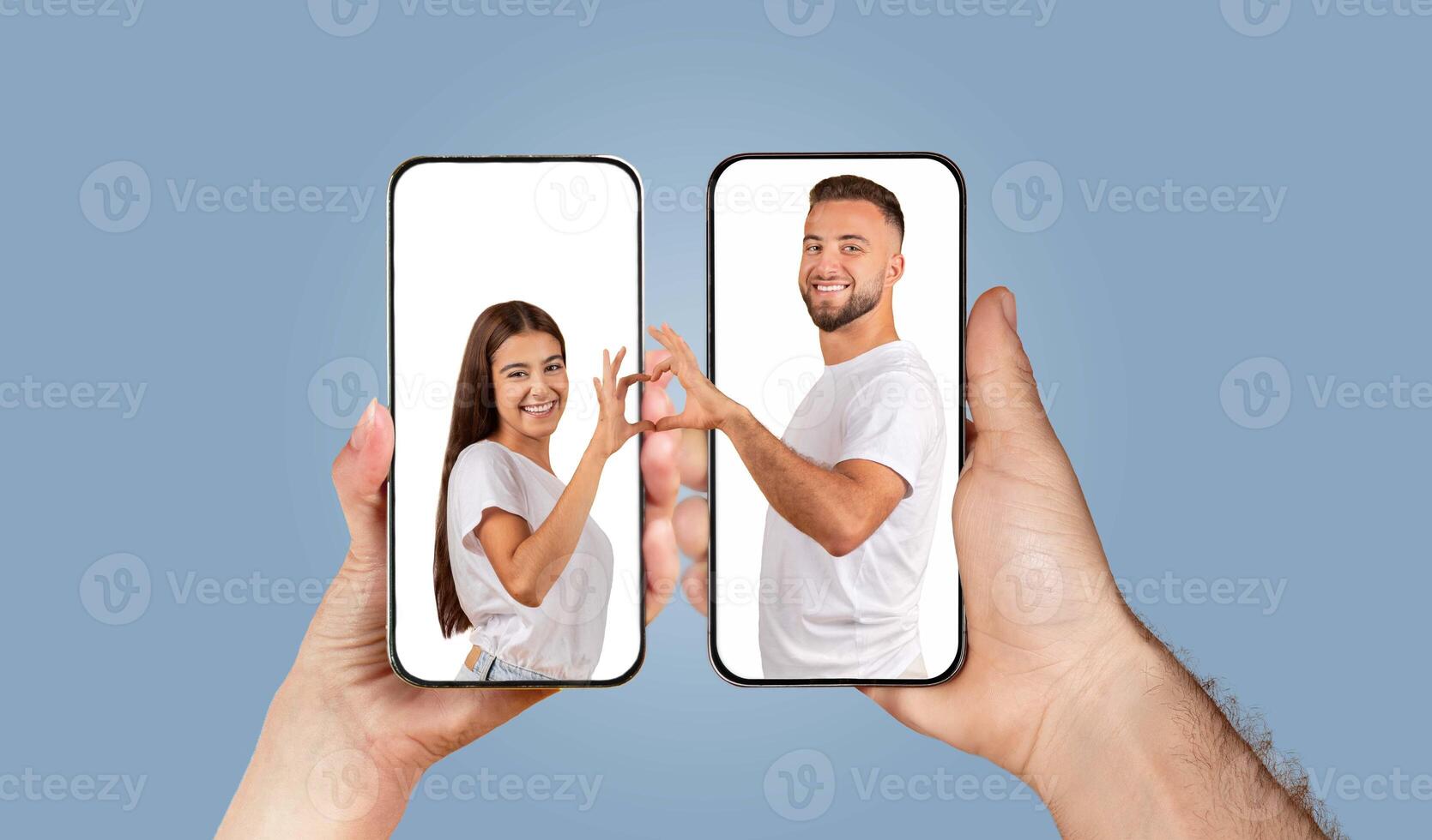 A couple expresses their love and connection by chatting through smartphones. Their hands reach out toward each other, showcasing their bond despite the digital barrier of a screen. photo