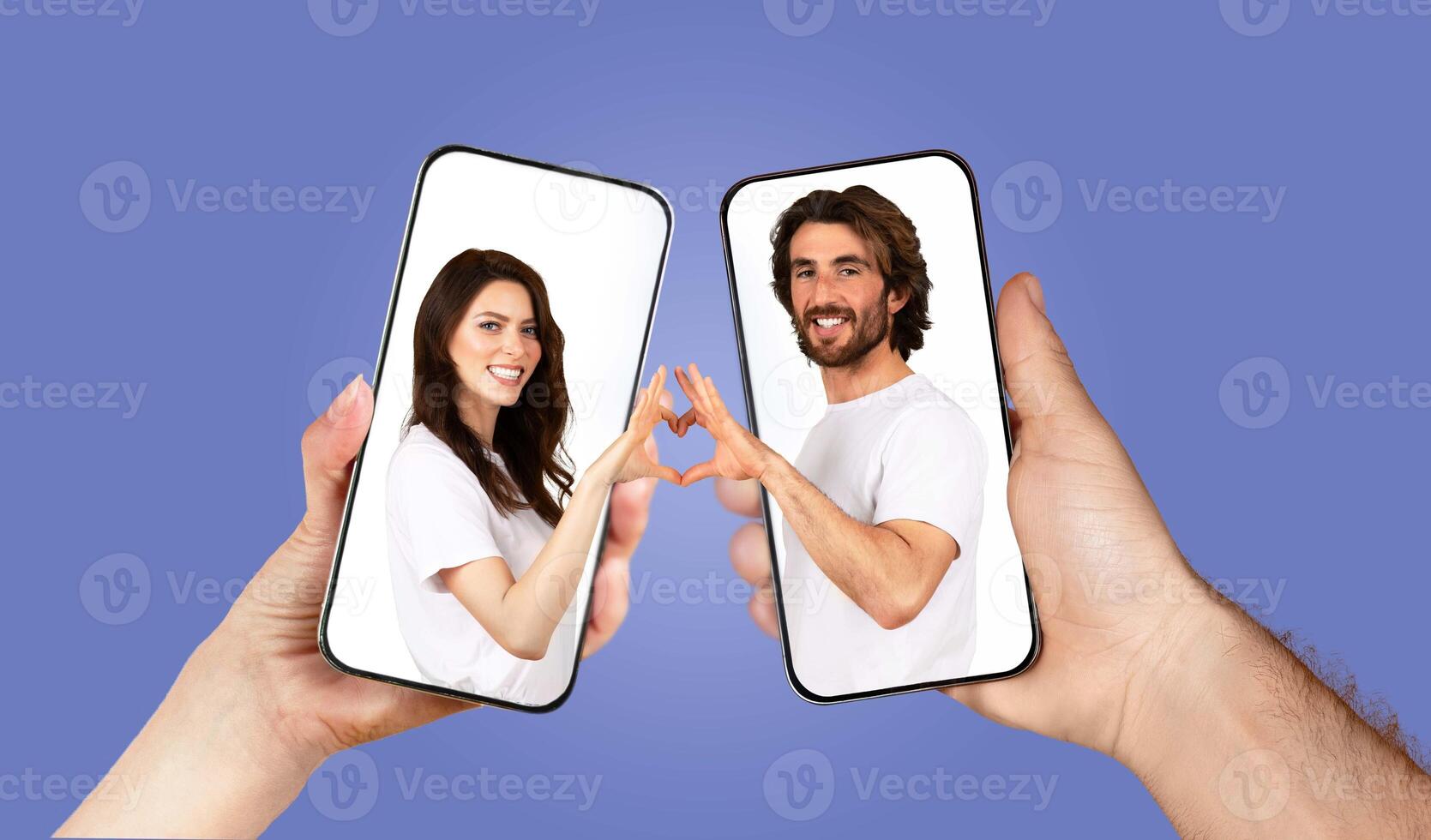 A couple connects emotionally through their smartphones, expressing love and affection. They create a heart shape with their hands while capturing the moment through an app. photo