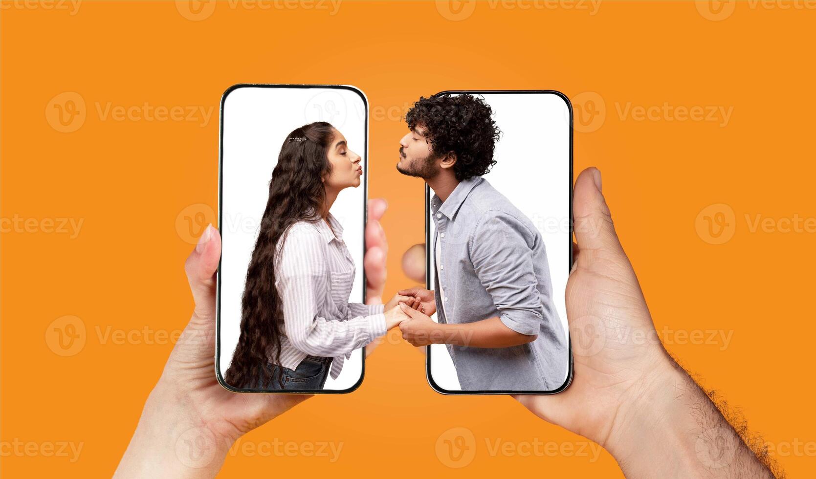 A couple engages in a loving interaction, holding hands and communicating through smartphones. They appear to be sharing a special moment while using a chat application. photo