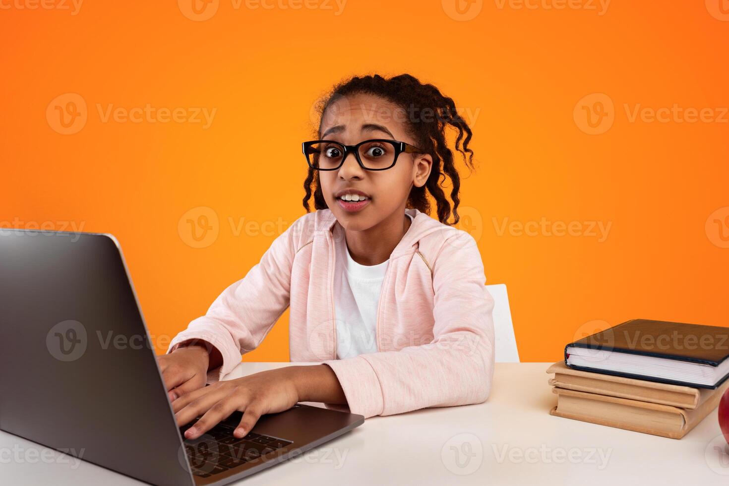 Too Much Homework. Portrait Of Shocked African American School Girl Working On Laptop, Typing On Keyboard, Wearing Eyeglasses And Looking At Camera Over Yellow Studio Background. Banner photo