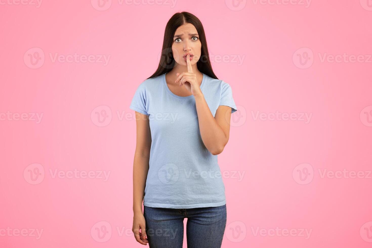 Secret, Gossip And Confidential Private Information. Portrait Of Serious Lady Putting Finger On Lips, Showing Gesture Of Silence, Gesturing Hush Sign, Standing Isolated Over Orange Studio Background photo