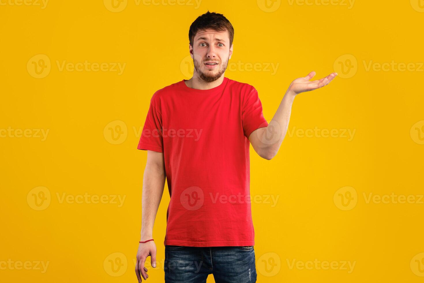 Who Knows. Portrait Of Funny Confused Man Shrugging Shoulders With Tipping Hand, Looking At Camera Posing Over Blue Background. Studio Shot. Puzzled guy is clueless. I'm sorry, exuse me, can't decide photo