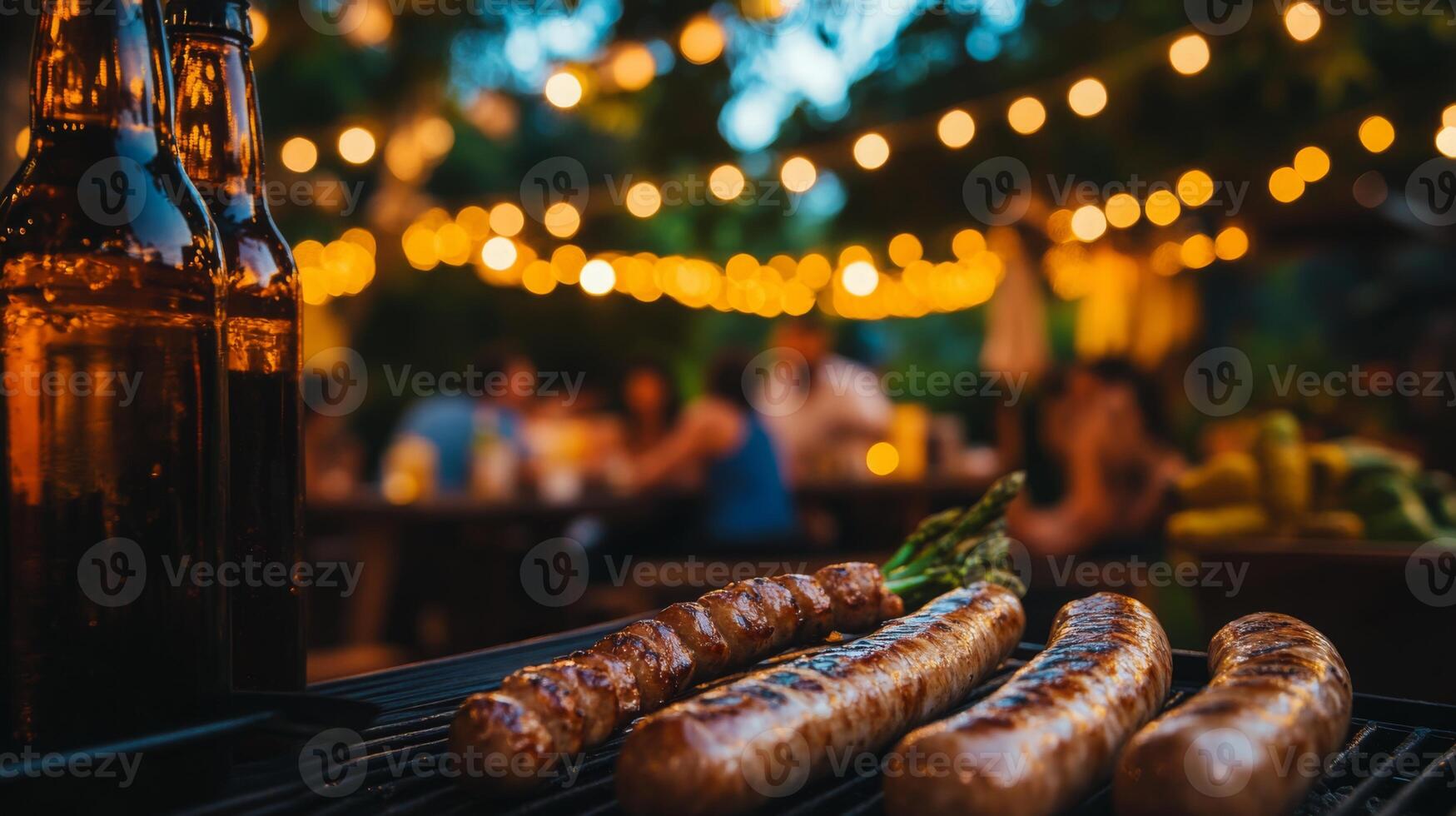 Juicy sausages sizzle on the grill while friends gather in a warm, inviting atmosphere. Twinkling lights create a festive mood during this outdoor cooking experience. photo
