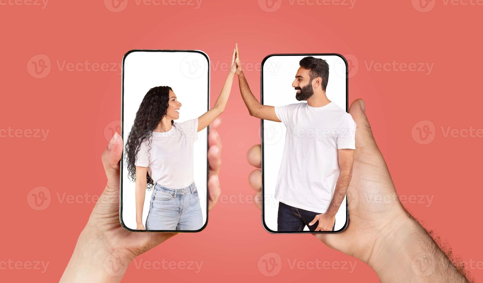 A couple engages in a loving interaction using their smartphones. They are smiling and reaching towards each other from their screens, showcasing the power of technology in connecting hearts. photo