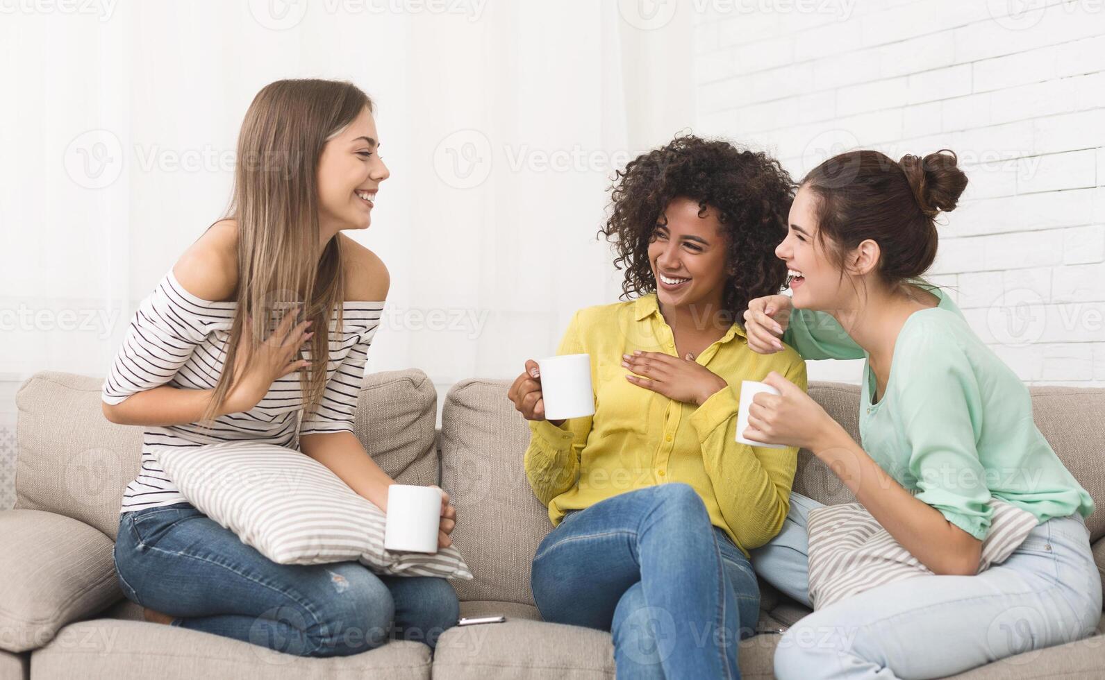 Girlfriends spending time together and drinking tea at home photo