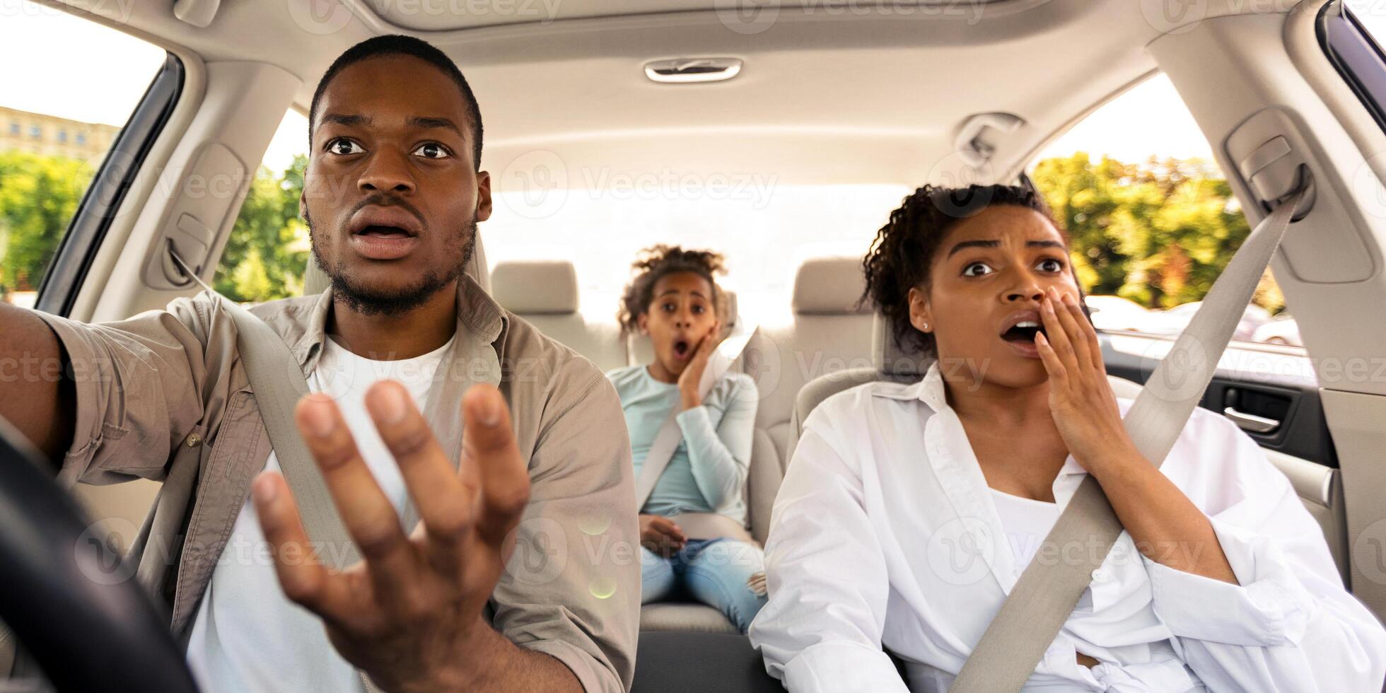 Car Accident. Shocked African American Family Driving Automobile Having Problem And Risk Of Auto Crash Riding In City. Transportation And Traffic Issues Concept. Selective Focus photo