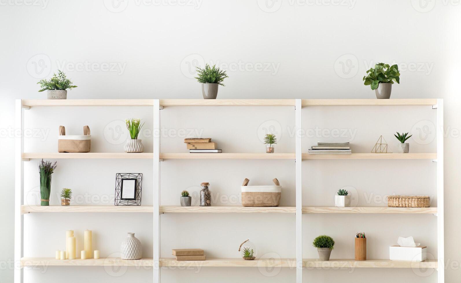 Scandinavian furniture with decorative elements in daylight. Gray wall and shelf with potted plants and accessories in modern living room, office or bedroom interior, flat lay, copy space, indoor photo