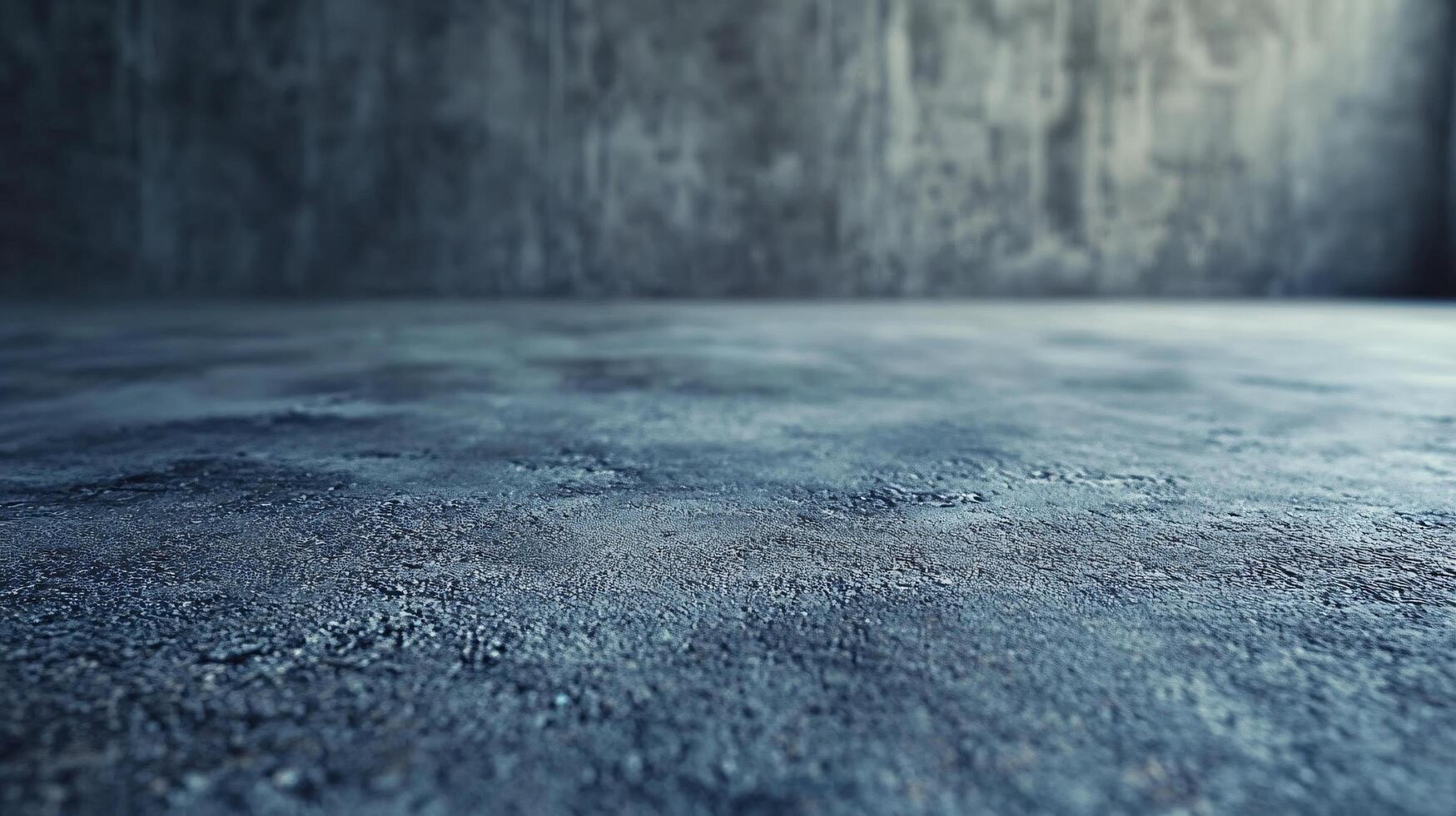 A grey concrete wall with a blue floor photo