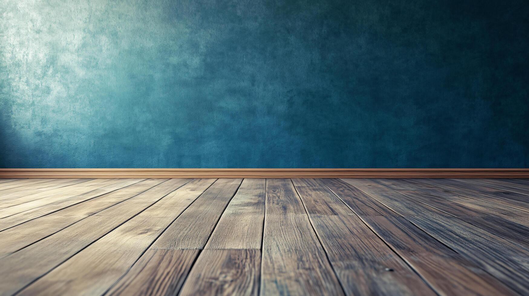 A large empty room with a blue wall and wooden floor photo