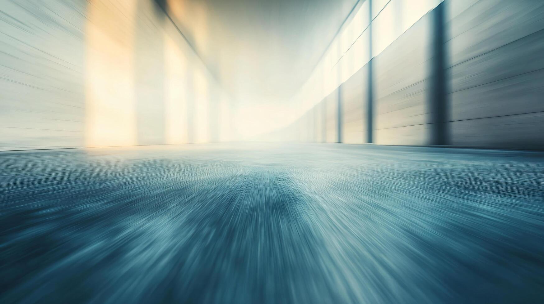 A blurry image of a large, empty room with a blue floor photo