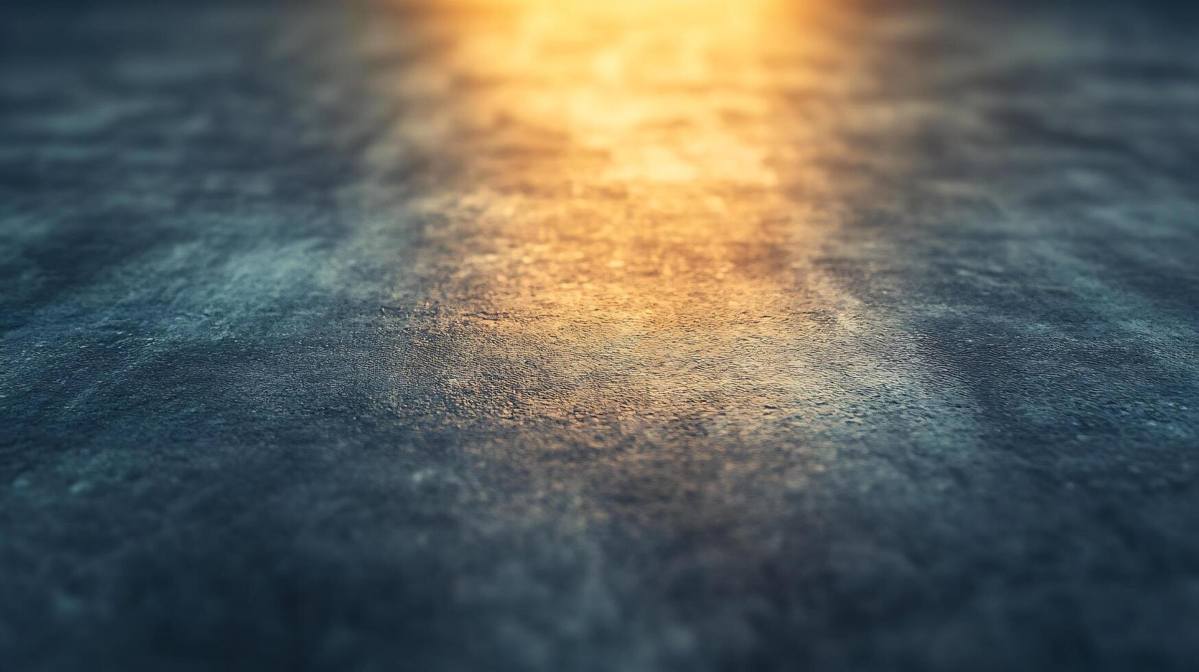 A blurry image of a dark surface with a yellowish hue photo