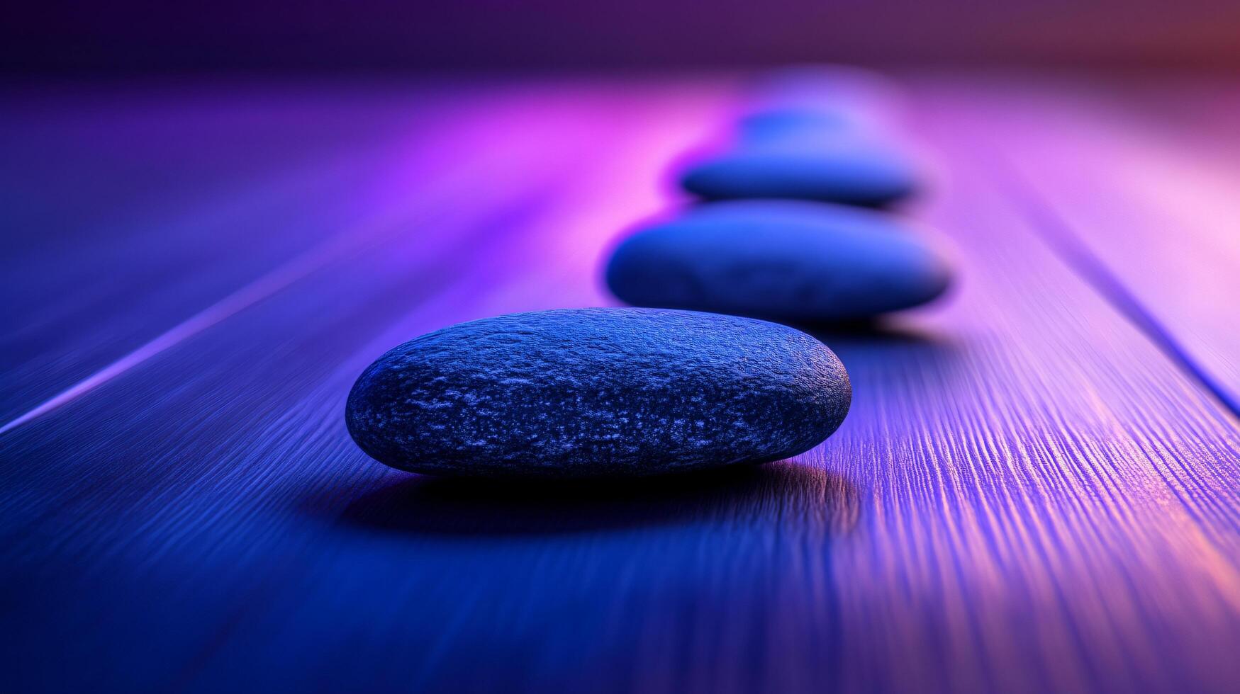 A row of blue stones on a wooden surface photo