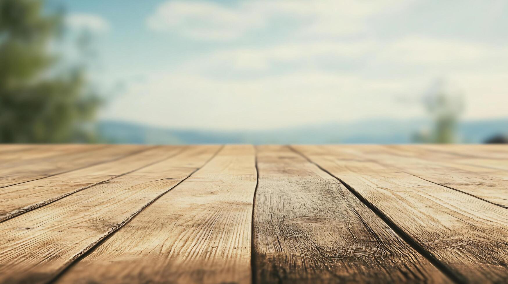 A wooden table with a view of the mountains in the background photo
