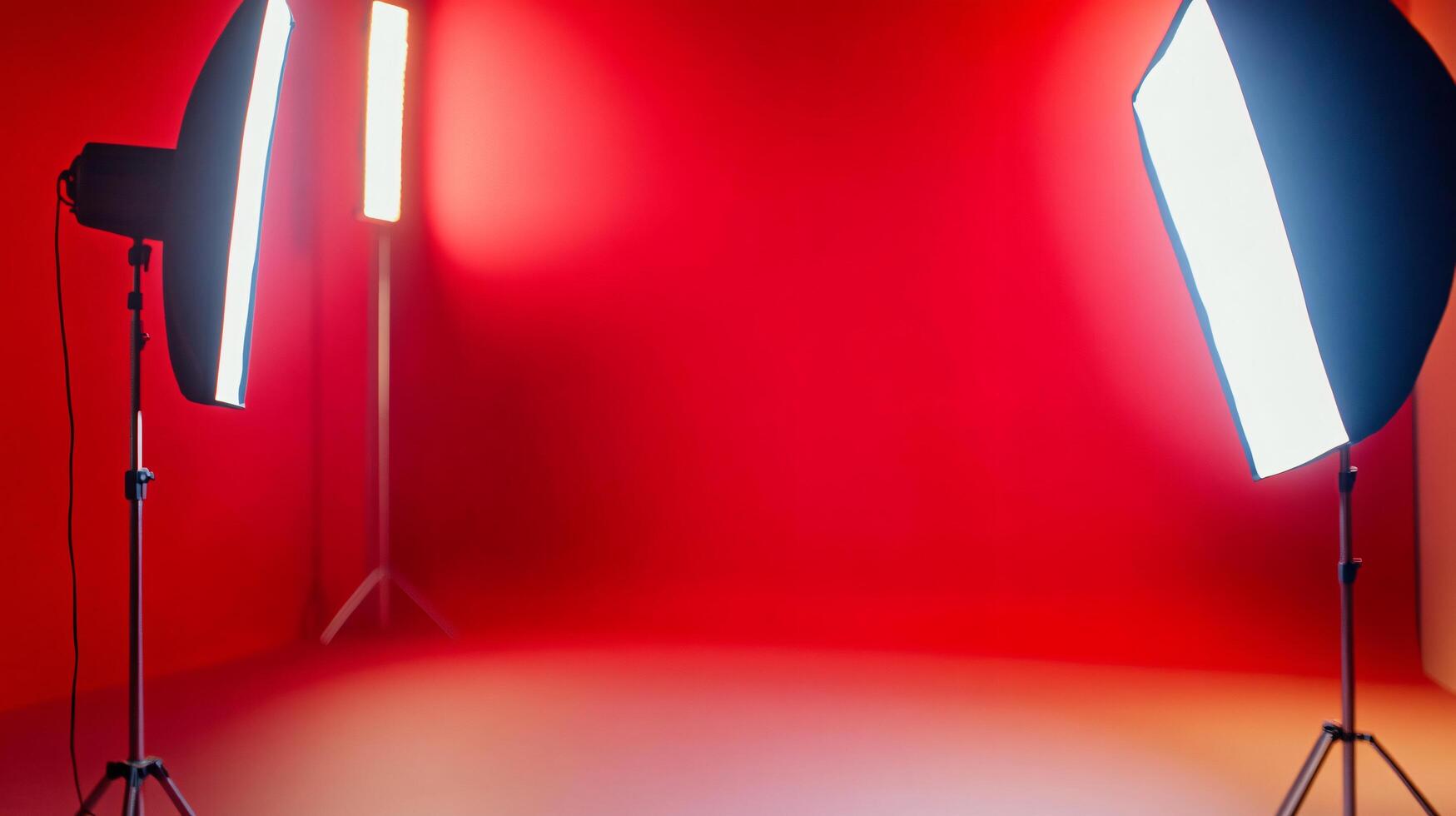 Two lighting fixtures are set up in front of a red wall photo