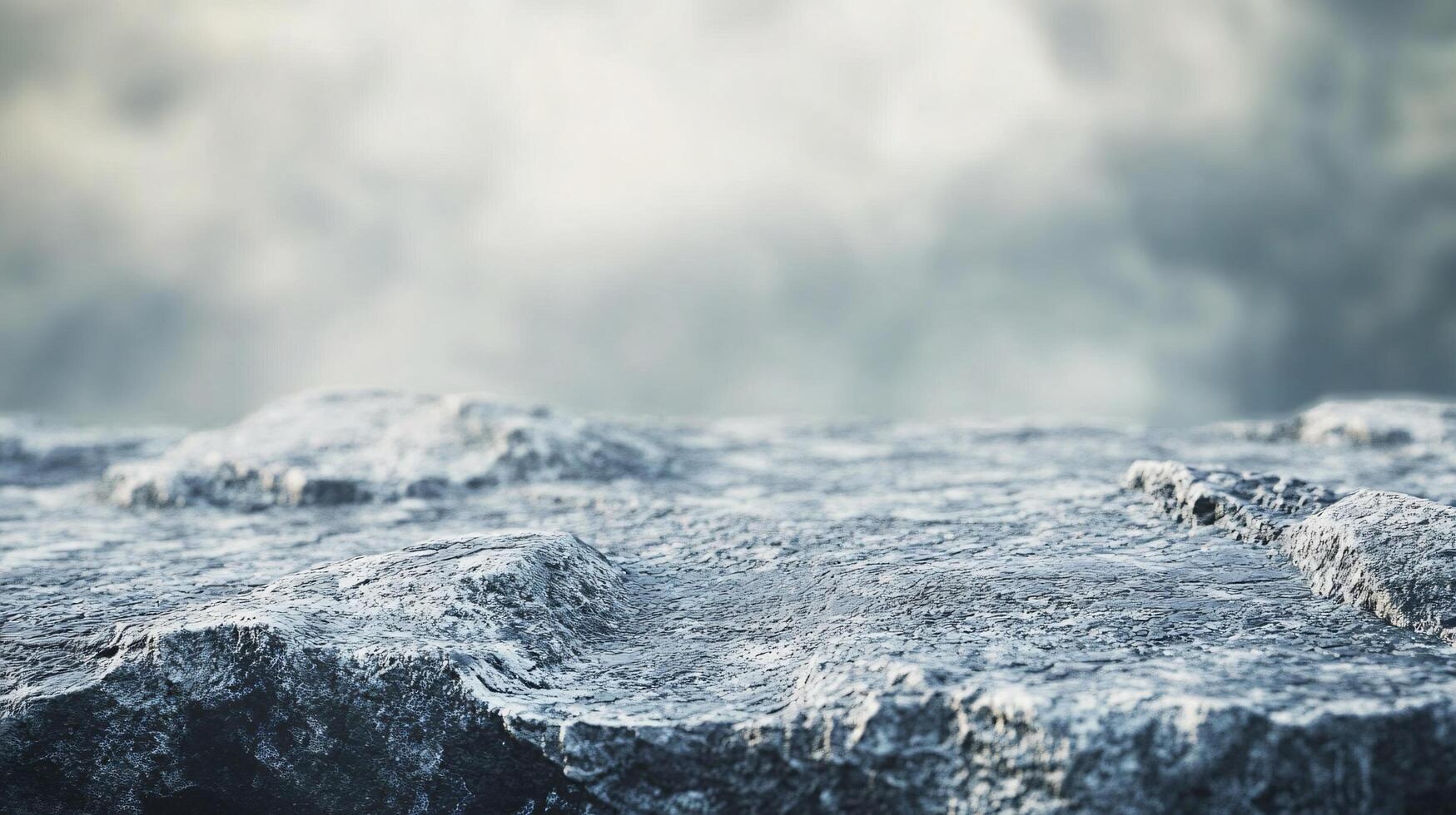 A rocky, snow-covered mountain with a cloudy sky in the background photo