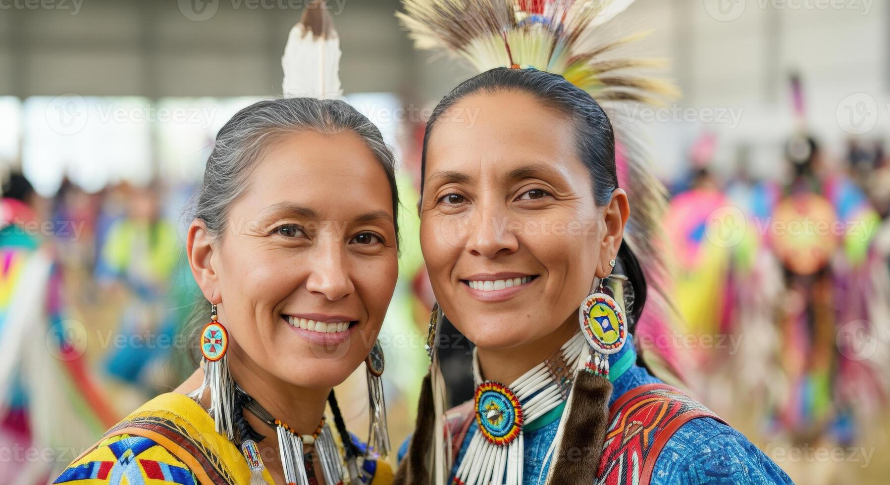 Indigenous celebration. two mature native american females in traditional regalia at cultural festival photo