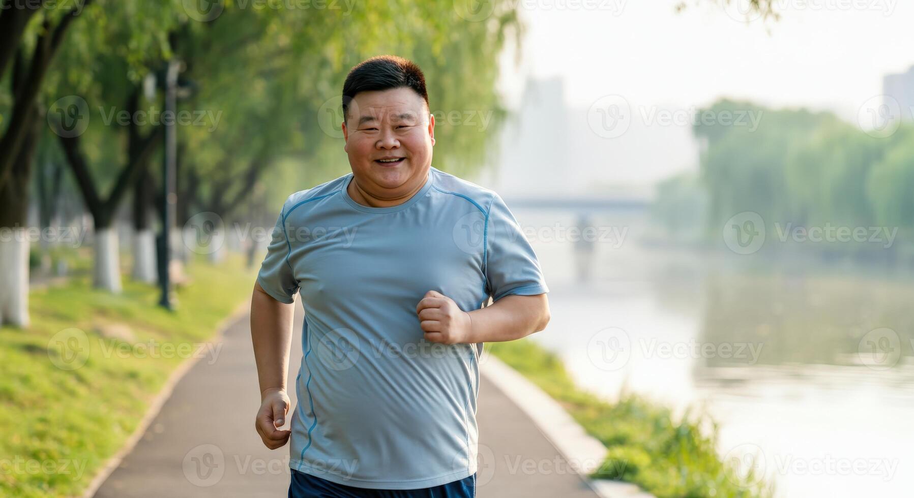 Asian mature man enjoying morning run in a park by the river photo