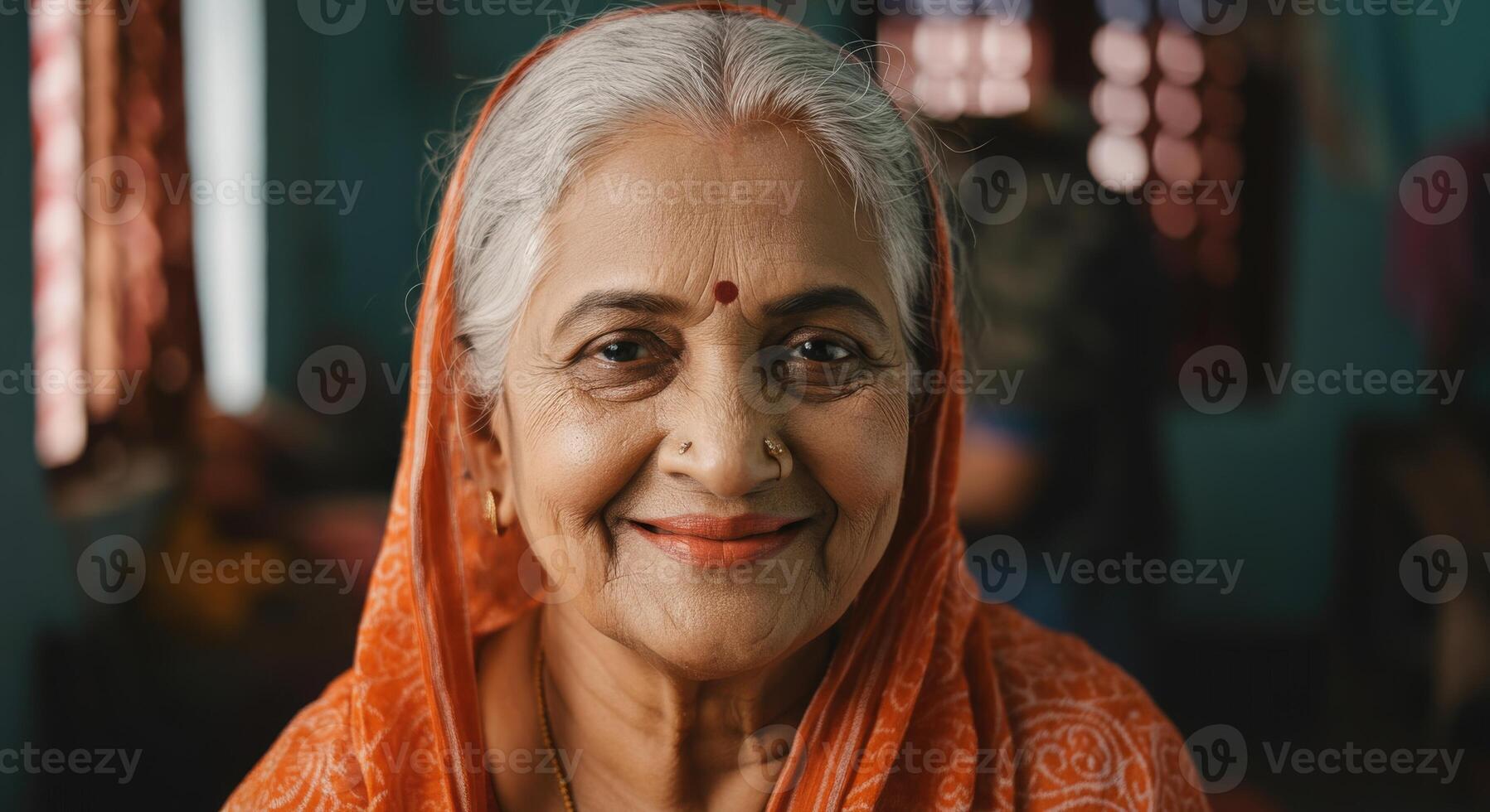 Portrait of an elderly indian woman in traditional sari with warm smile and cultural elegance photo